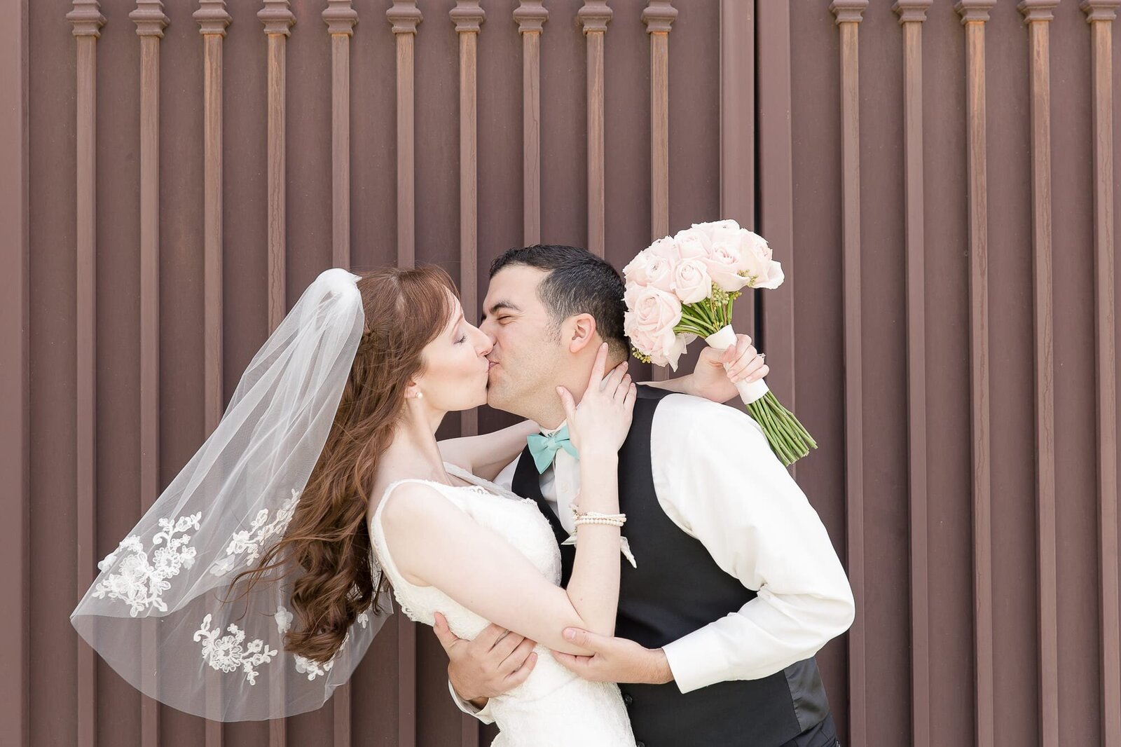kissing-bride-and-groom-noahs-event-center