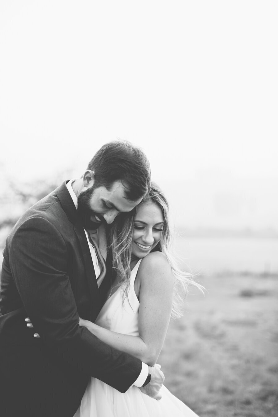 Black and white wedding photo of couple on Petaluma Beach