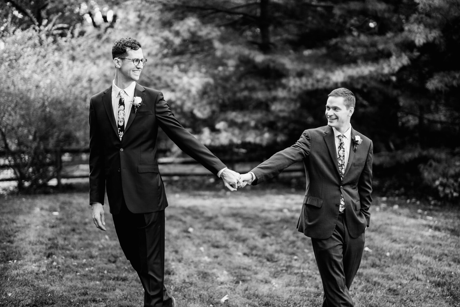 gay grooms holding hands nature