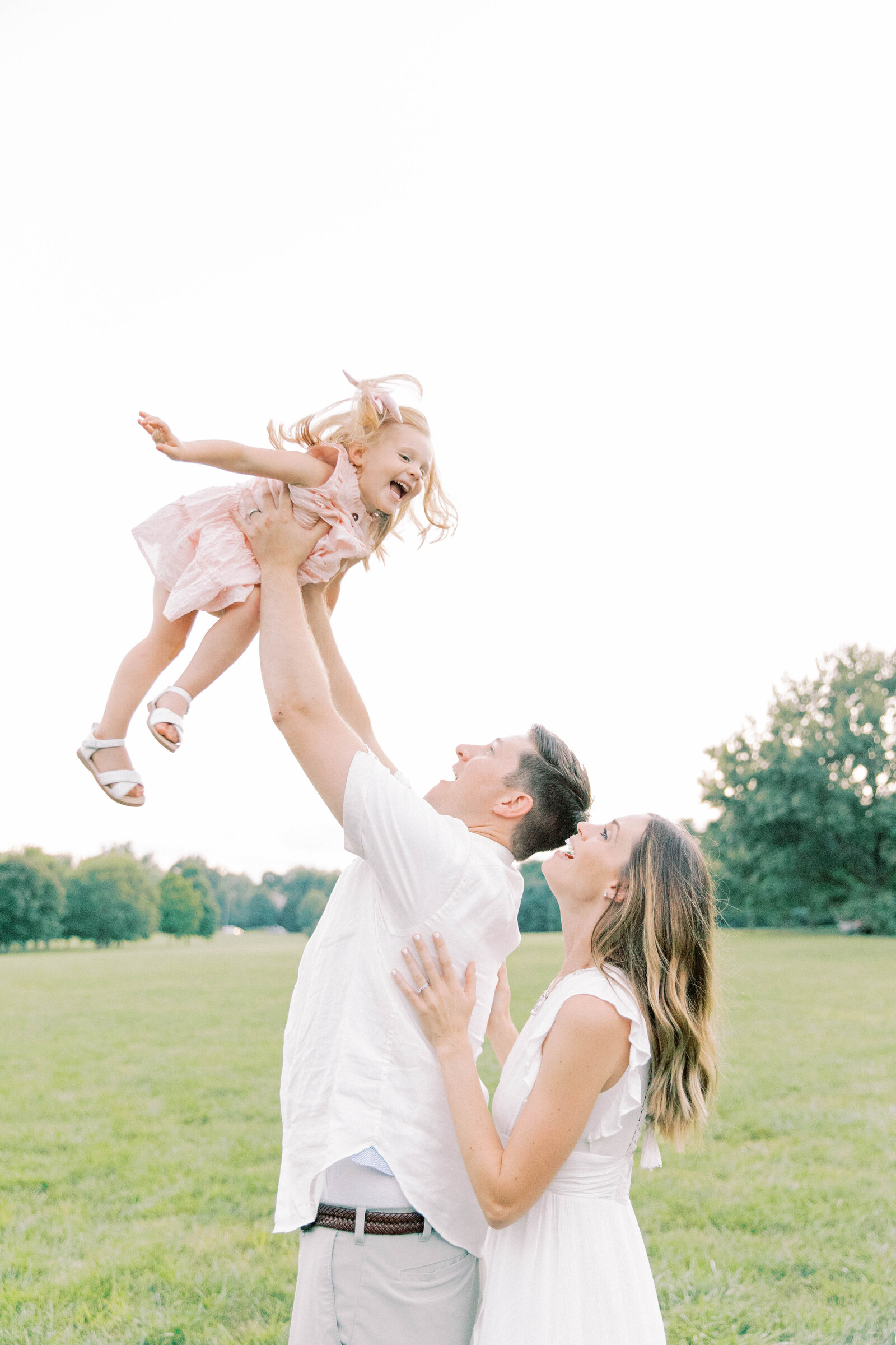 Playful family photos at Loose Park in pastels and light colors in the spring Kansas City