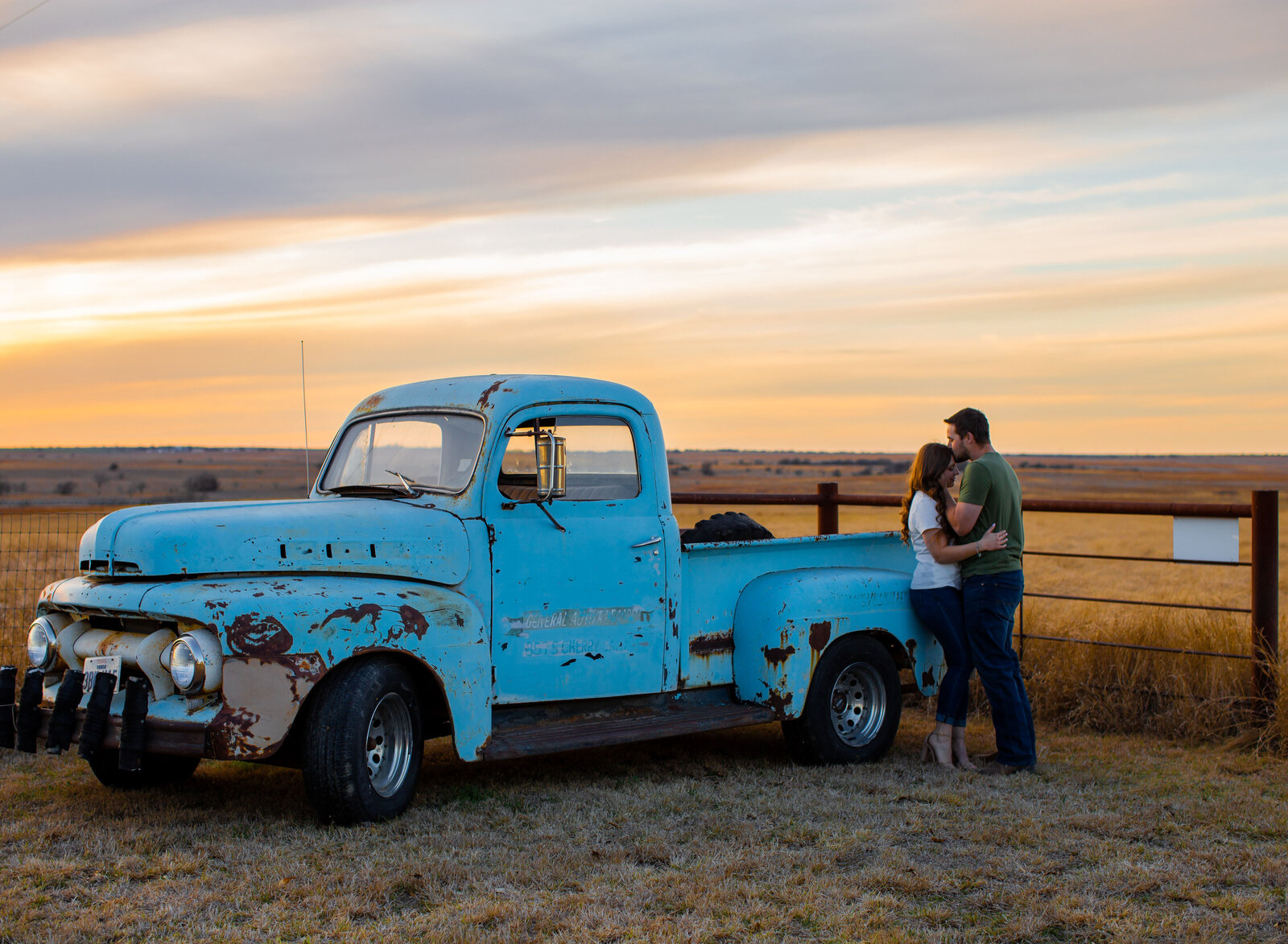 sweet couple with classic truck at sunset