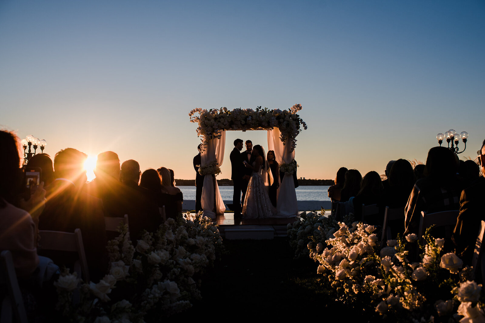 silhouette of couple suring ceremony with arbow