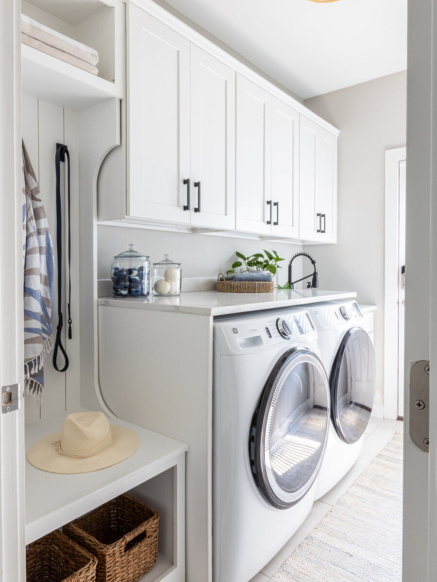 Laundry room with mini drop-zone, custom cabinetry and quartz countertops.