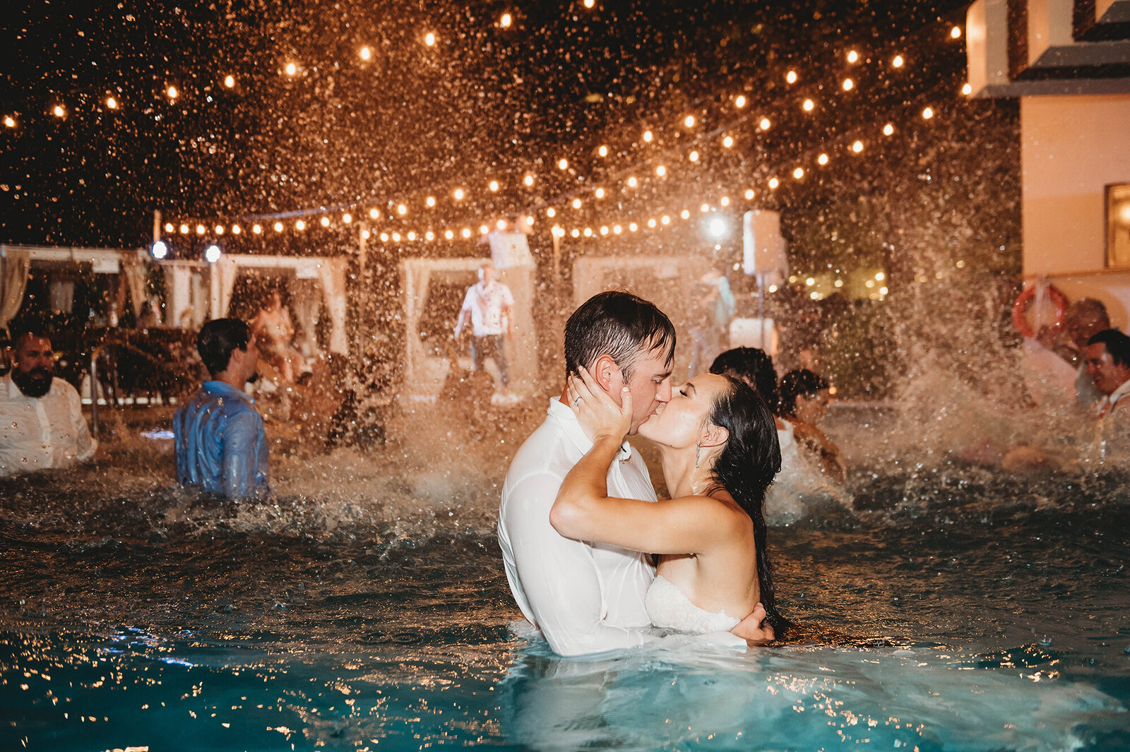 Newlyweds kiss in the pool at the end of their during their Micro-Wedding Reception at Live Aqua Resort in Cancun, Mexico.