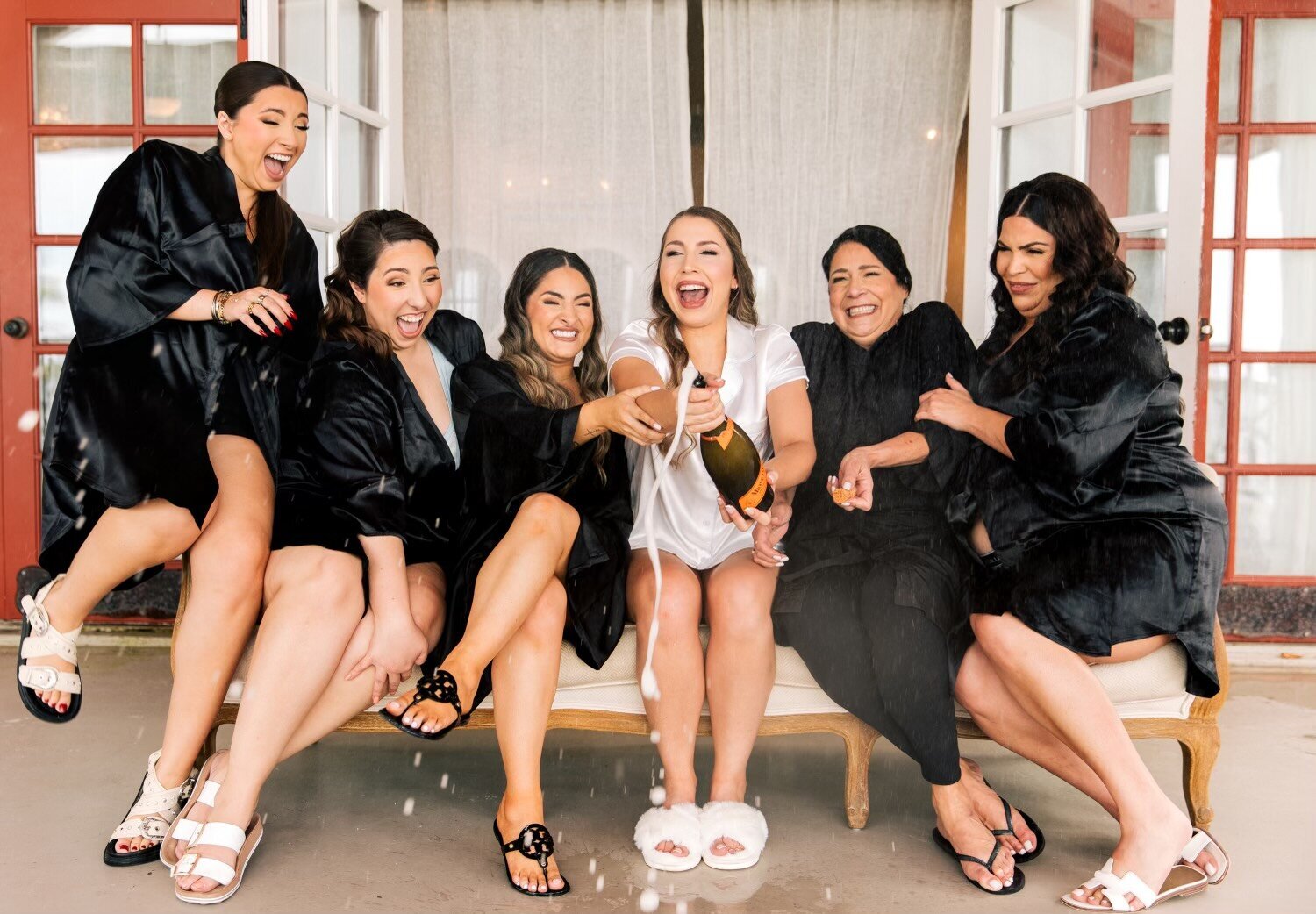 Bridal party laughing and getting ready at Blushed Miami salon, showcasing luxury beauty and bridal services.