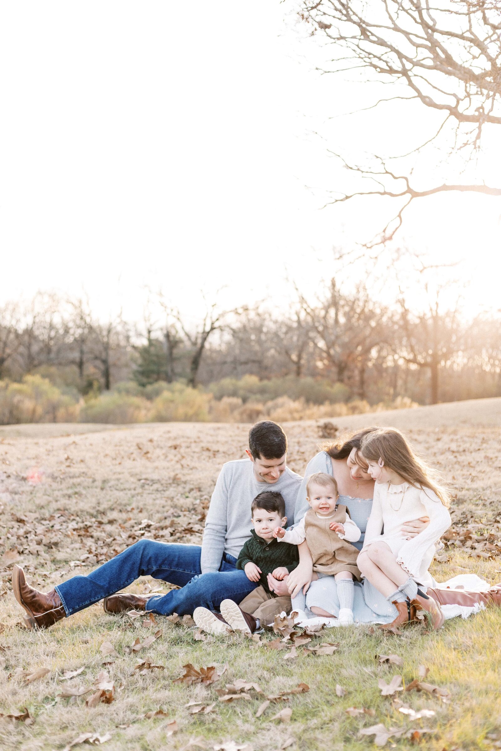 family sitting outside in sunset family photos in peoria illinois 
