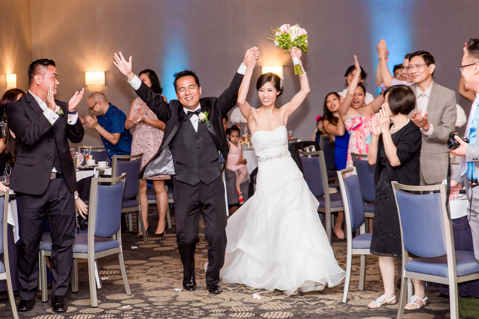 Bride and groom make their entrance in ballroom