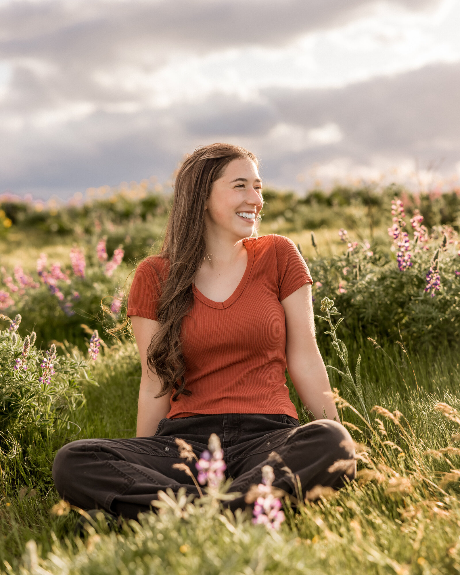 Girl sitting in a field of wildflowers