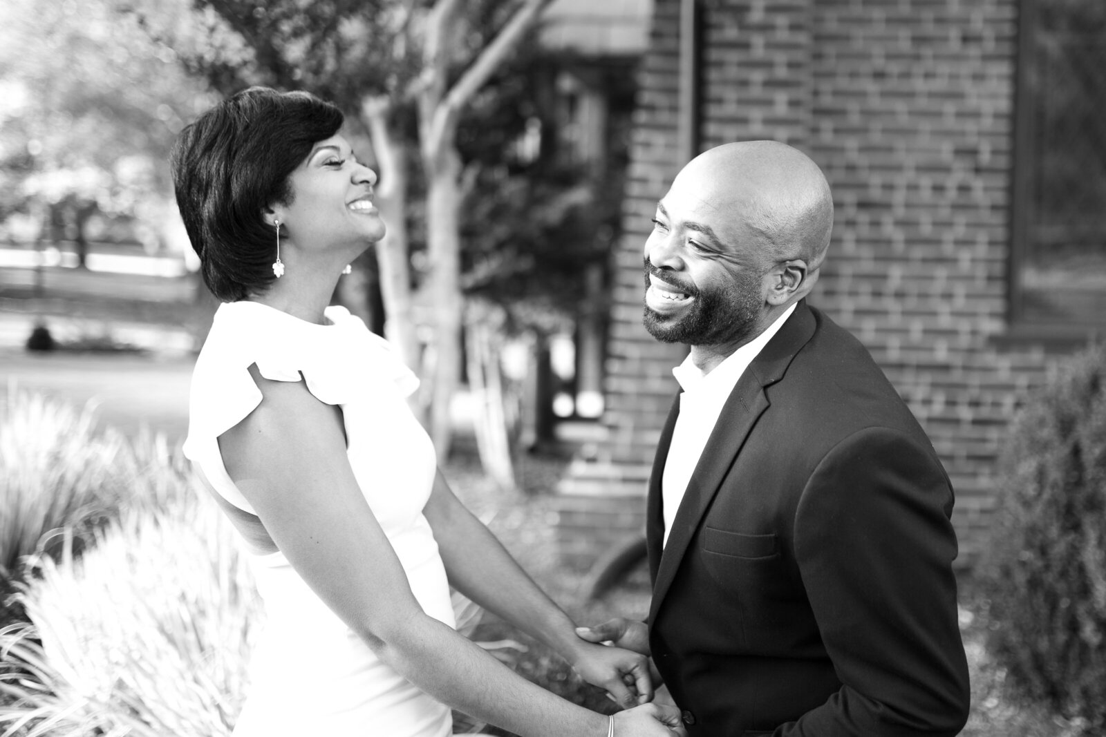 Black couple laughing and holding hands