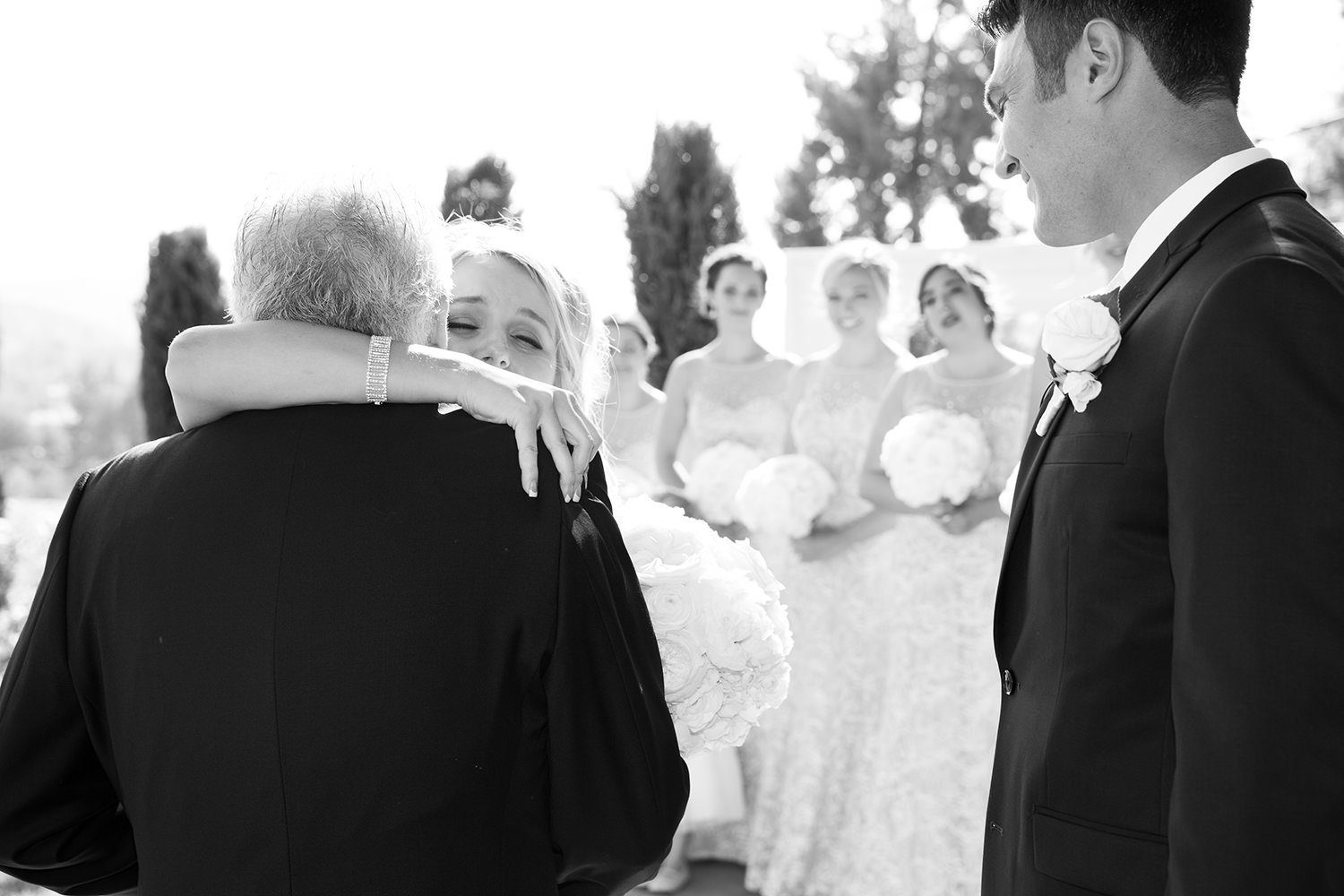 bride hugging dad at the end of the aisle
