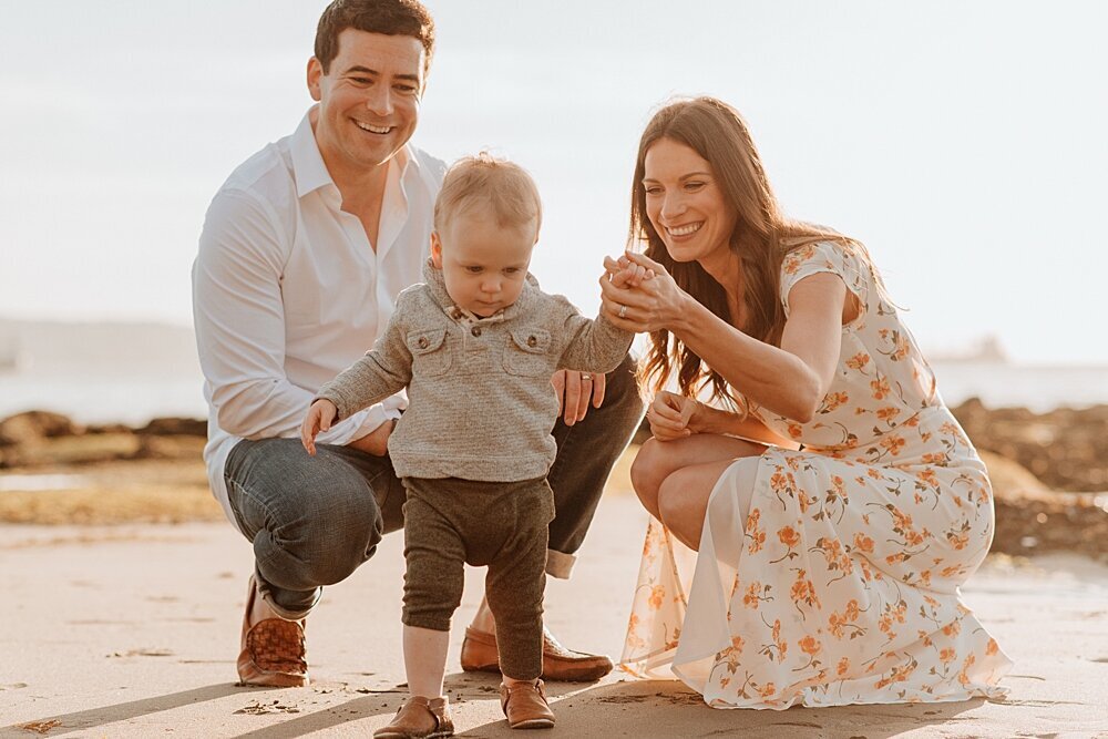 Family of three on beach at Stanley Park with Vancouver family photographer