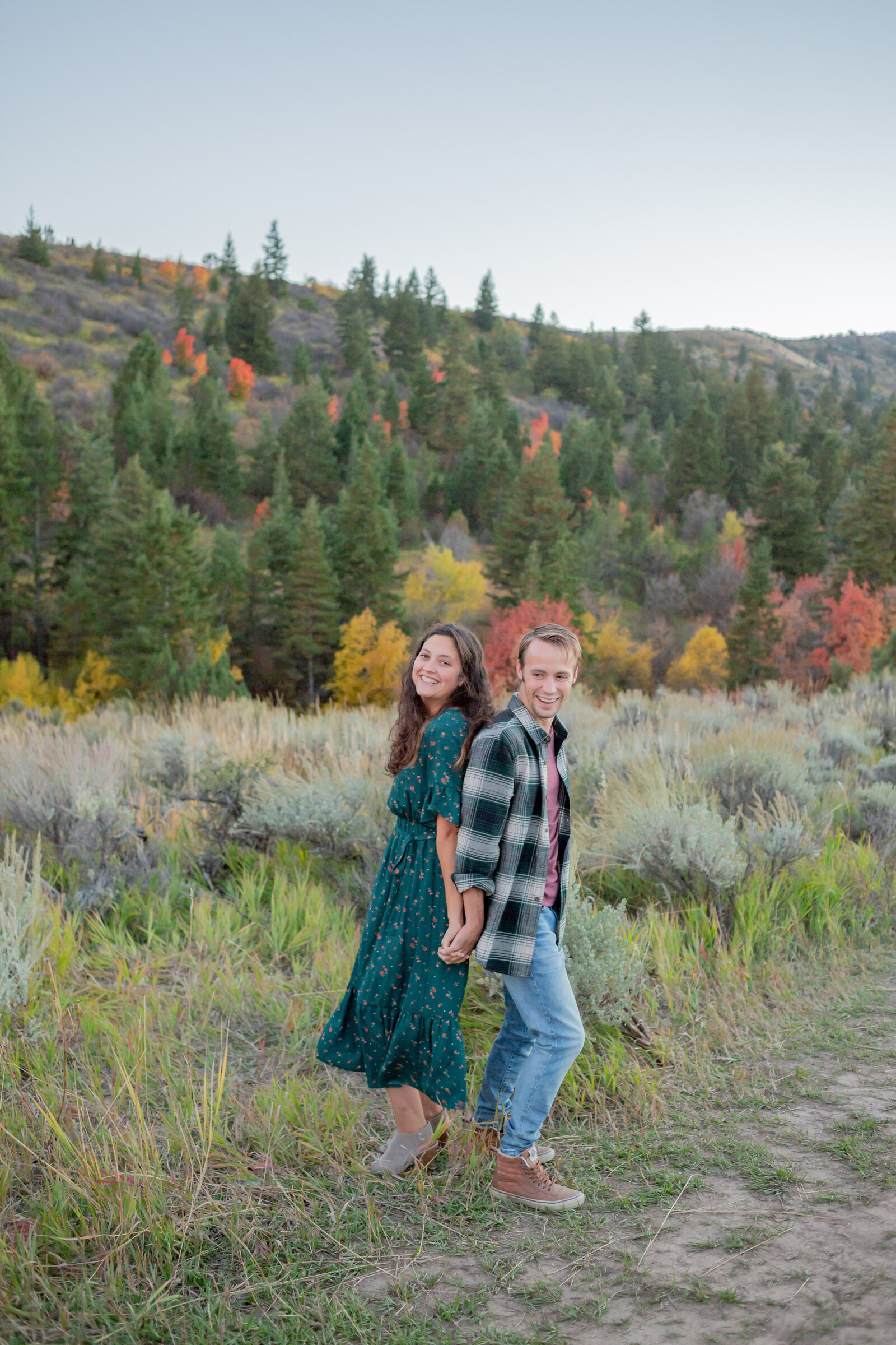 Seattle Wedding Photographer captures couple dancing in the mountains will fall colored trees all around