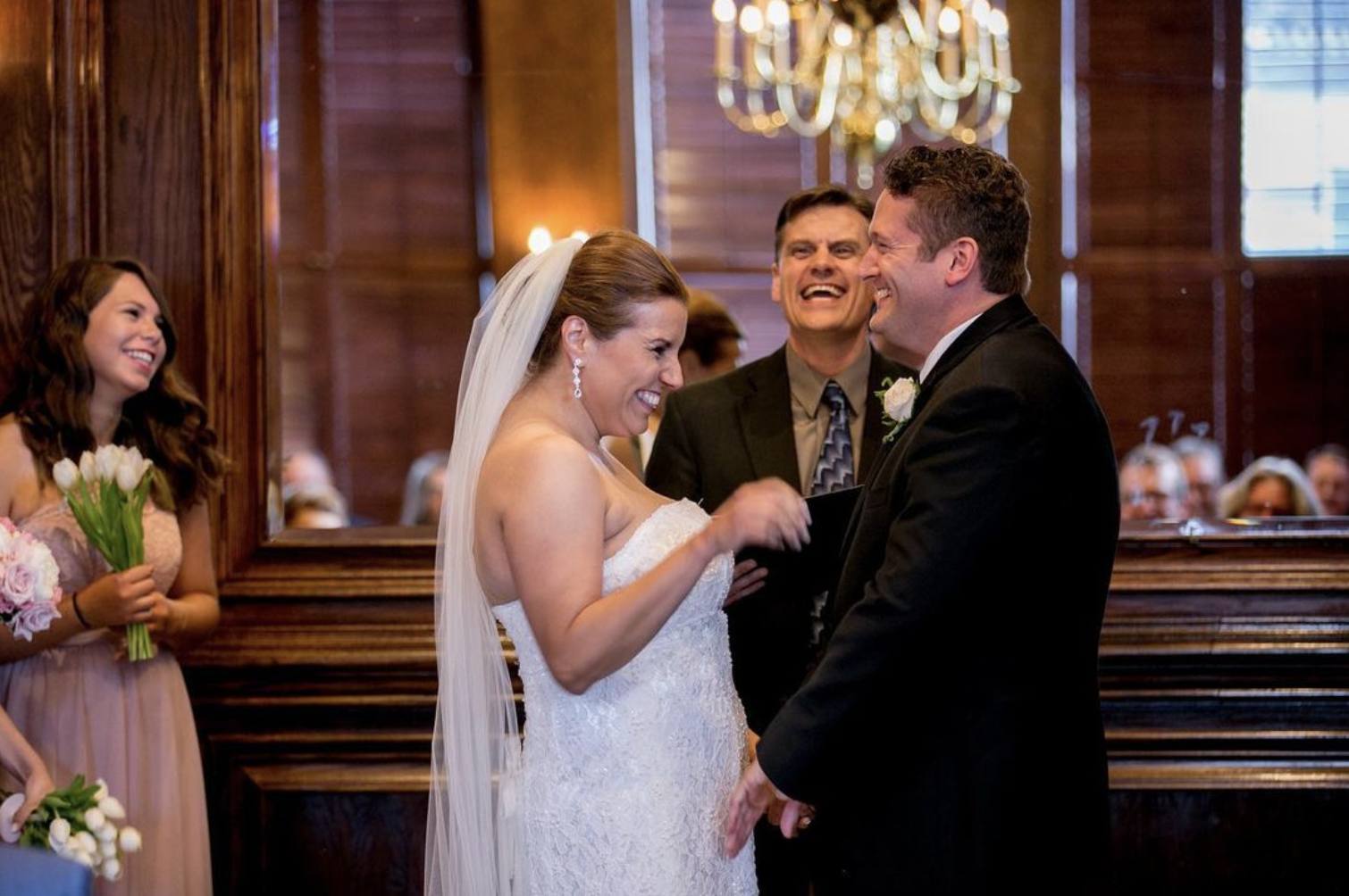 Bride and groom laugh during wedding ceremony