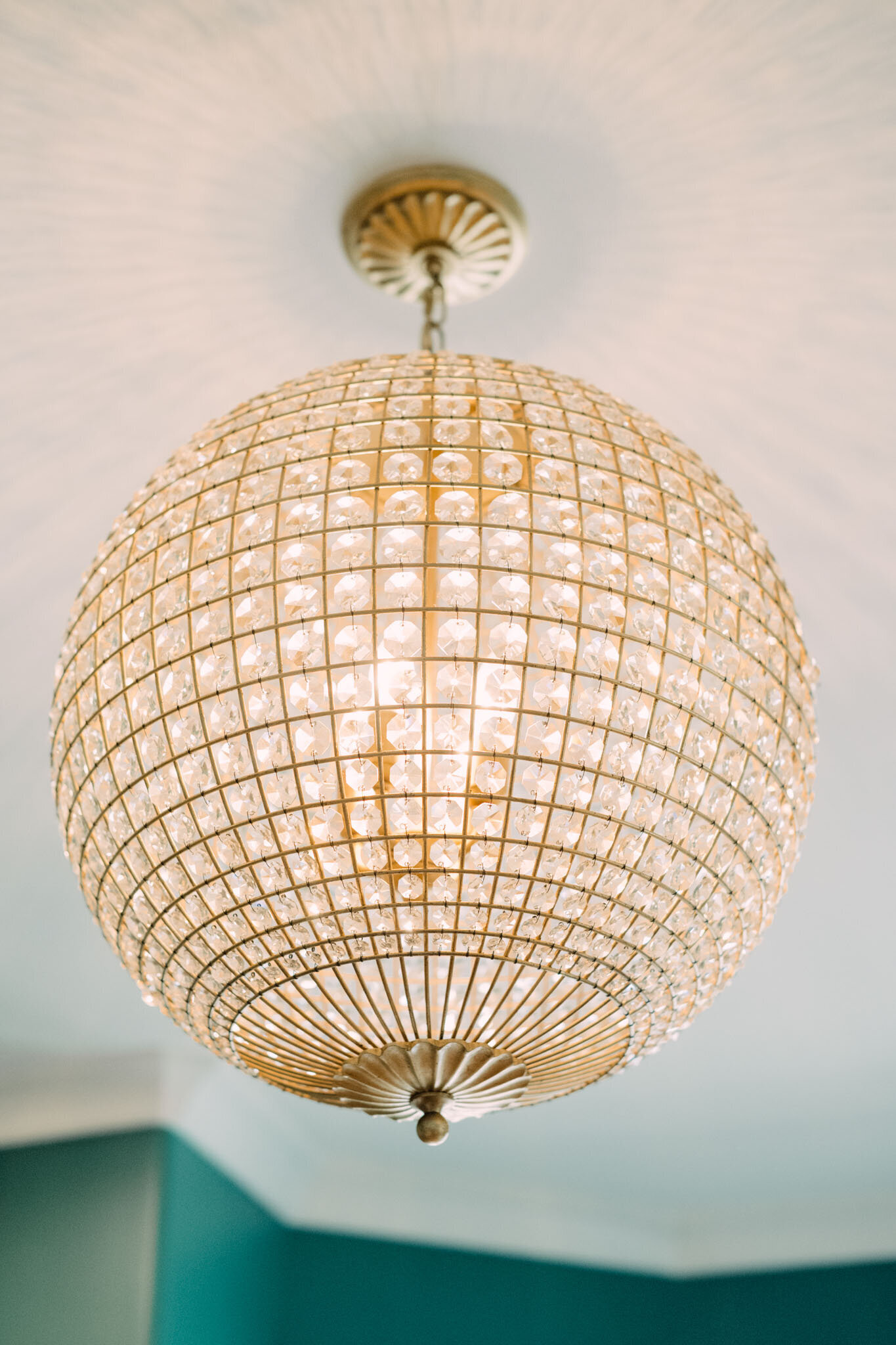 Close-up of a round crystal chandelier with gold accents