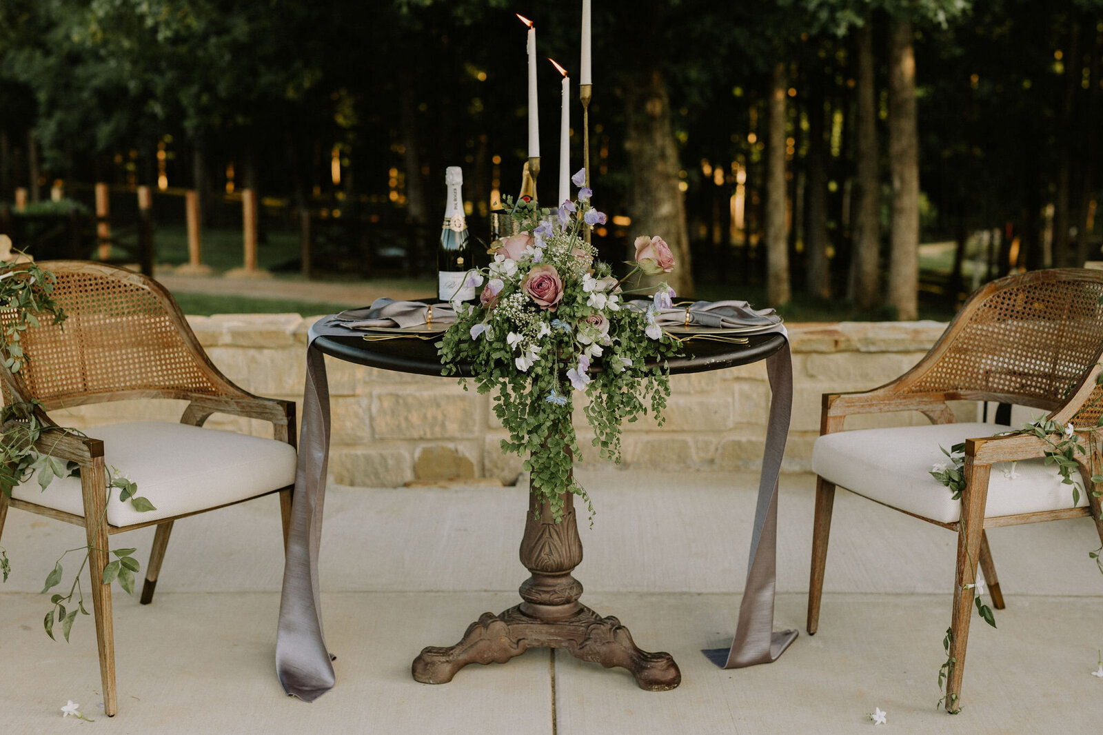 A sweetheart table with candles and flowers.