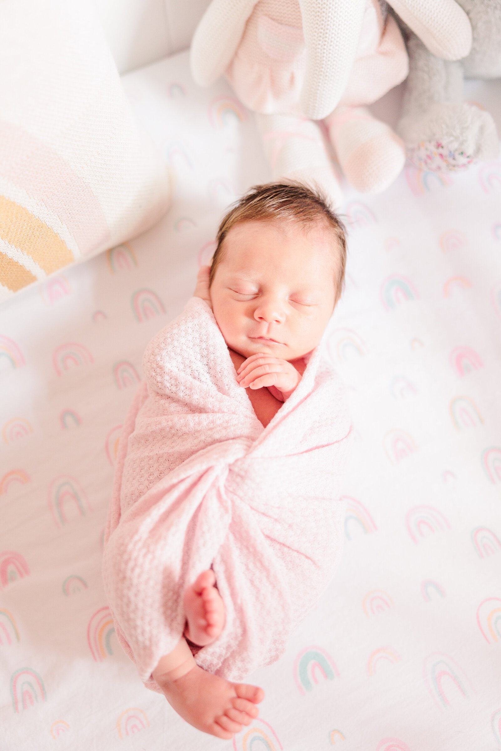 Akron newborn photographer light and airy pink baby girl swaddle asleep in crib