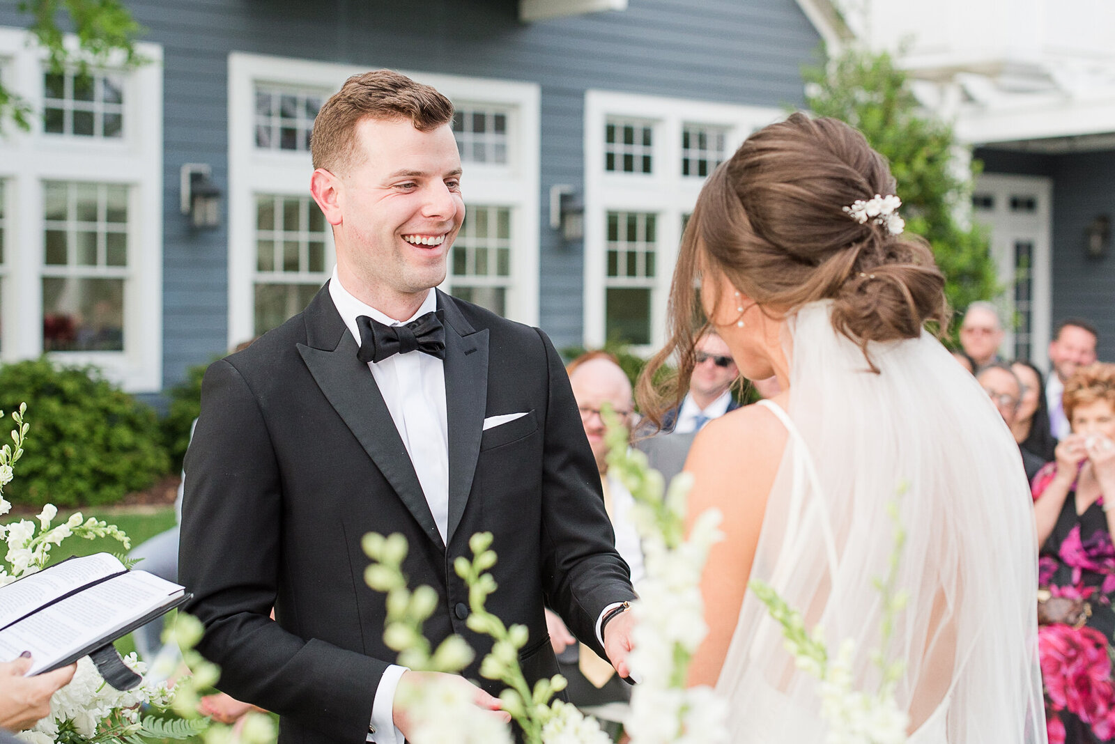 groom smiling at bride during ceremony