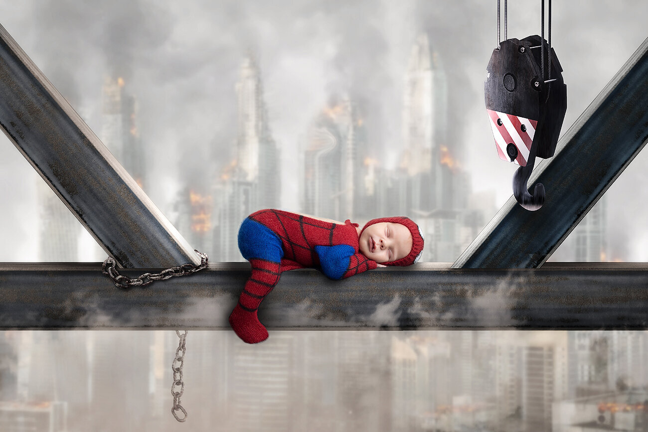 Newborn boy as spiderman.