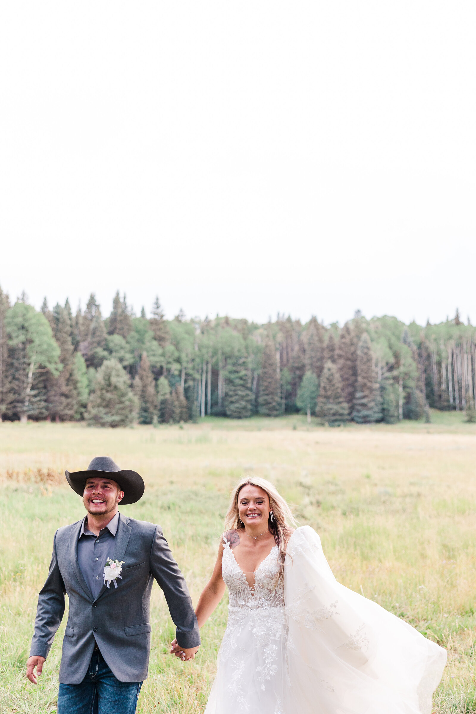 Close up capture of candid photo of bride and groom running and laughing