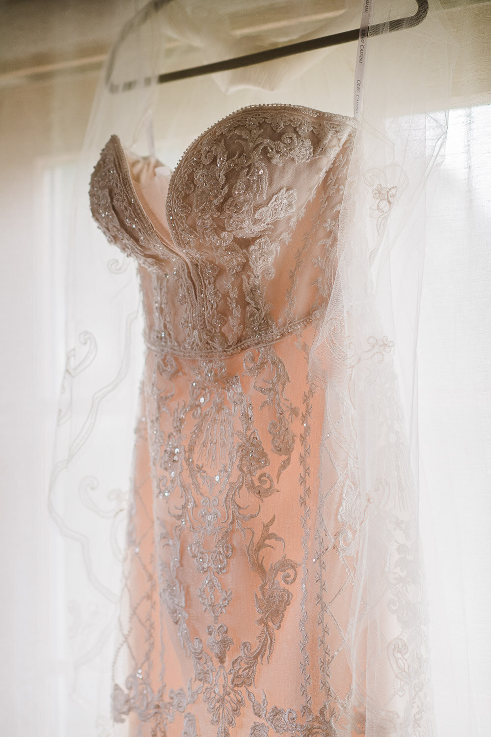 champagne and lace wedding dress in window