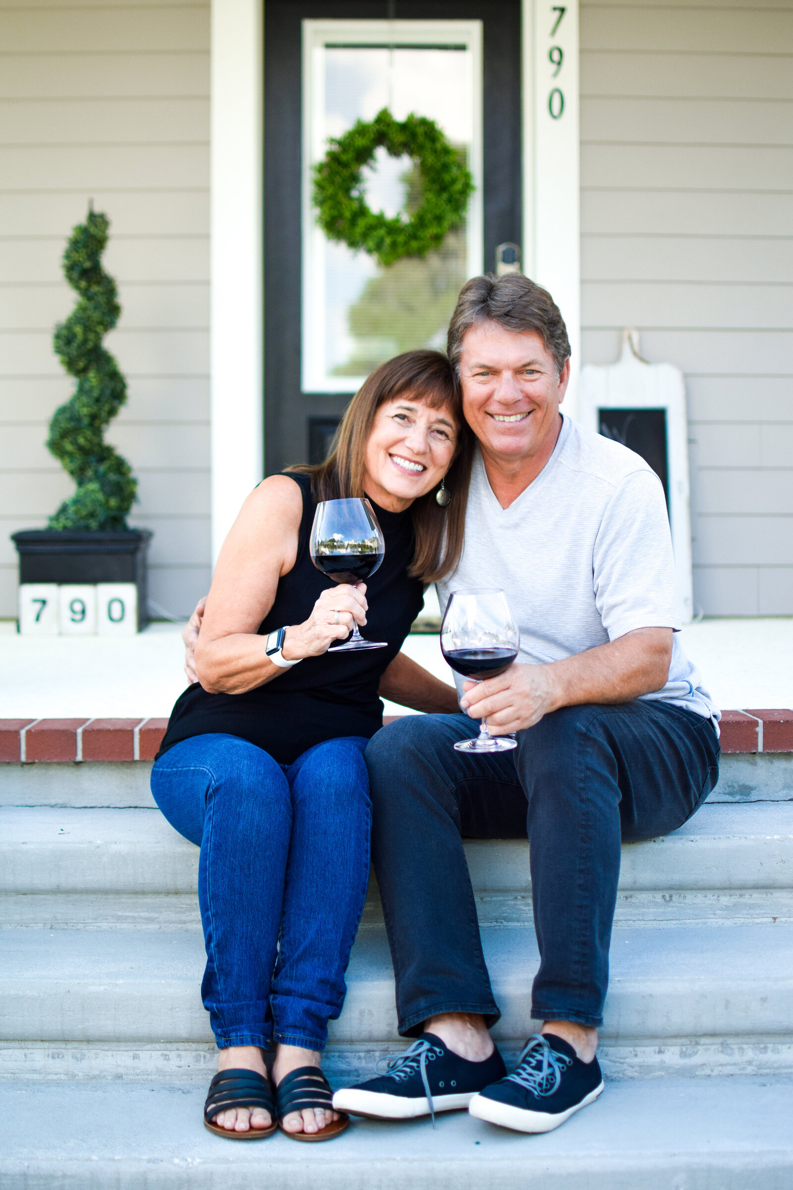 Couple cuddling wine front steps Front Porch Project Oakland Florida