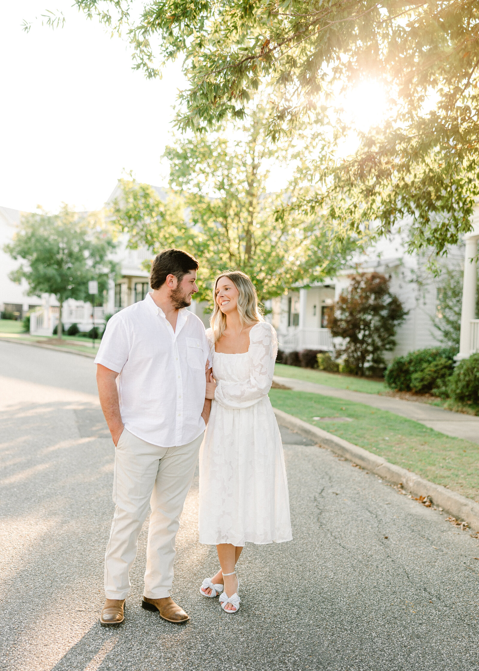 Kelby and Mason holding hands in a scenic field, captured by Abby Bell Photography. Romantic and timeless Alabama couples photography.