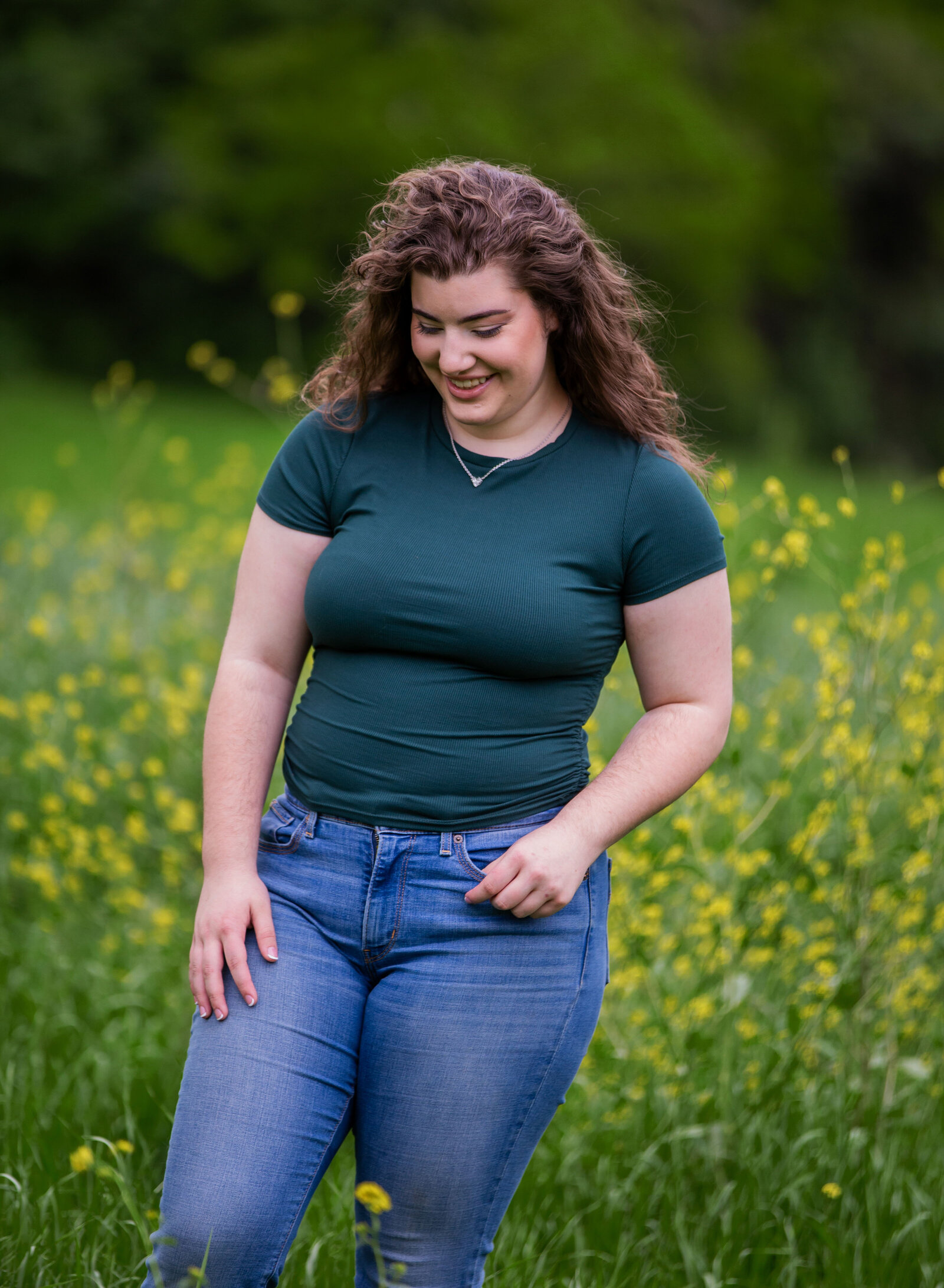 senior girl laughing in flowers