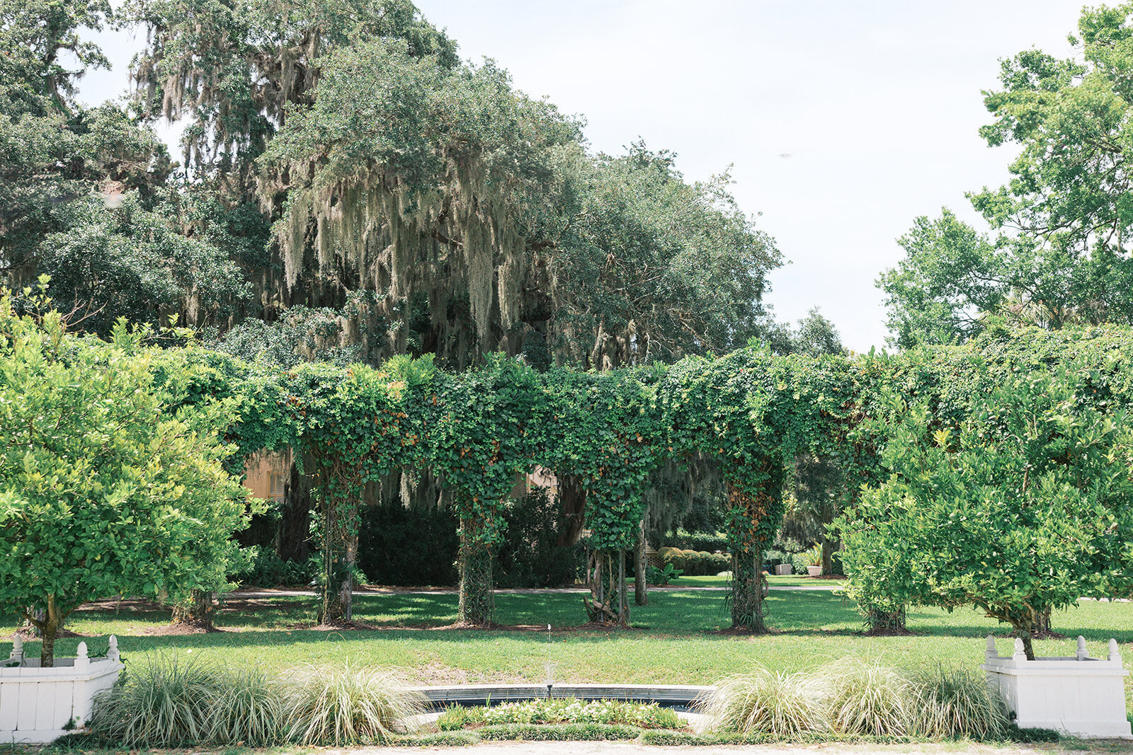 Crane Cottage wedding ceremony courtyard trees and fountain