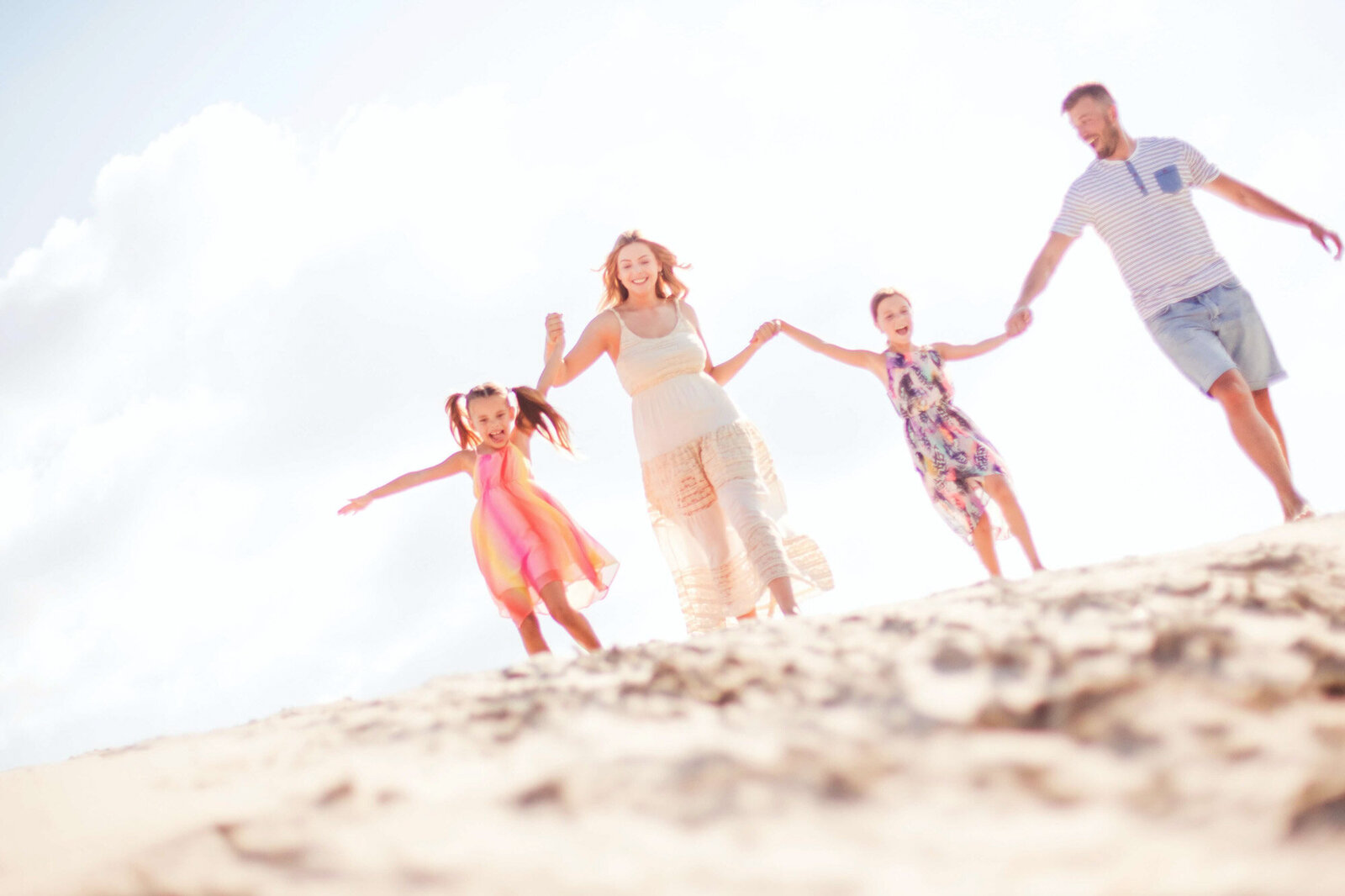 A family having fun in their vacation running on the seashore