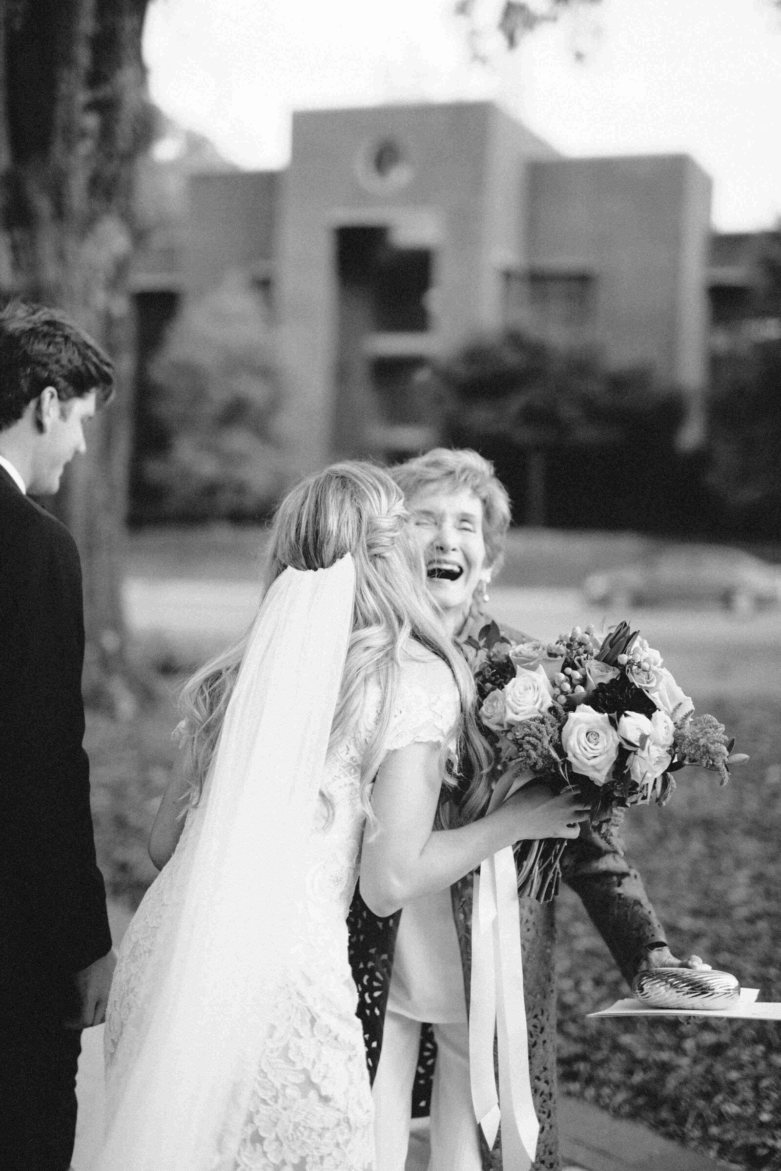 An emotional photo of a grandmother hugging and laughing with her granddaughter before she gets married at Dawson Baptist Church in Homewood, AL