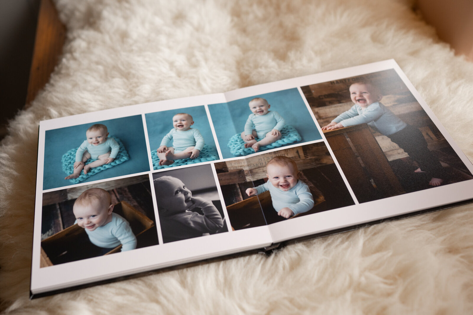 An open fine art photo album of a newborn open on a white fur blanket