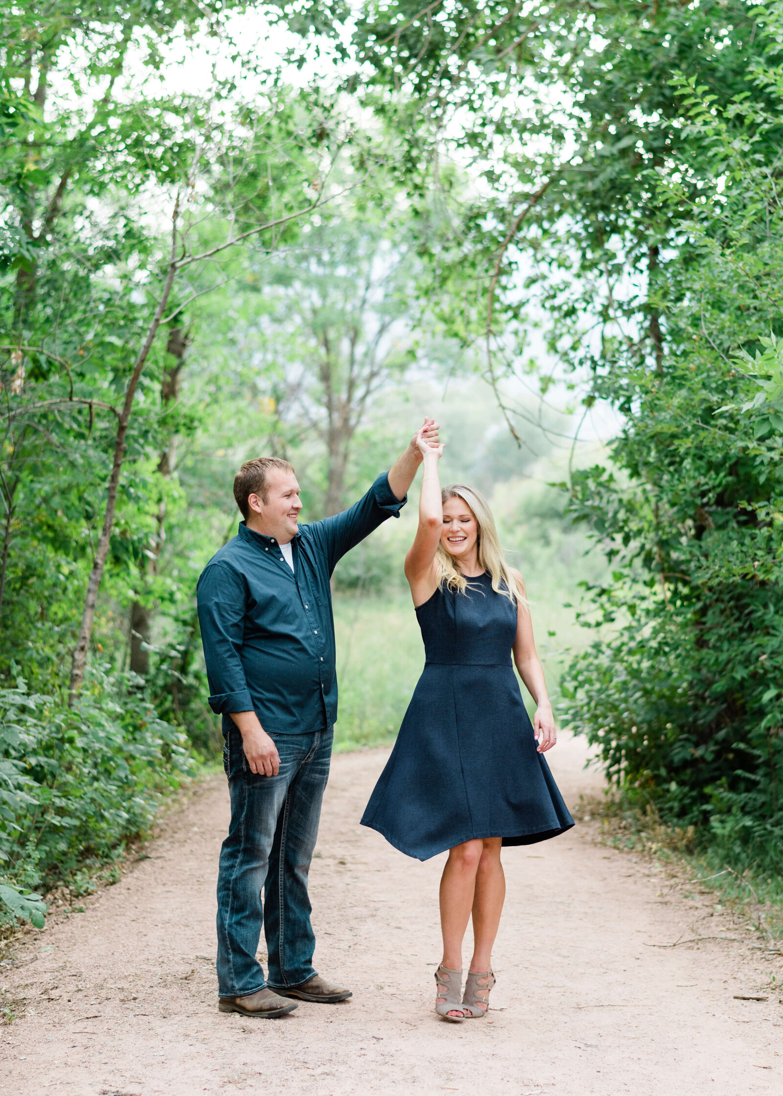 Man and Woman dancing on a path by Denver Wedding Photographer