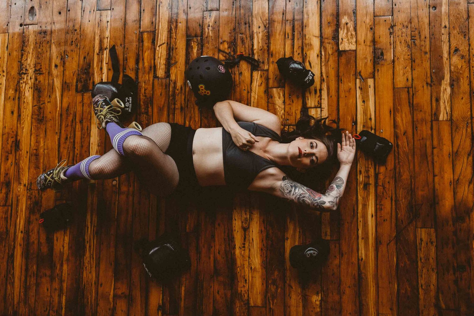 woman laying on the floor with gym equipment on her sides