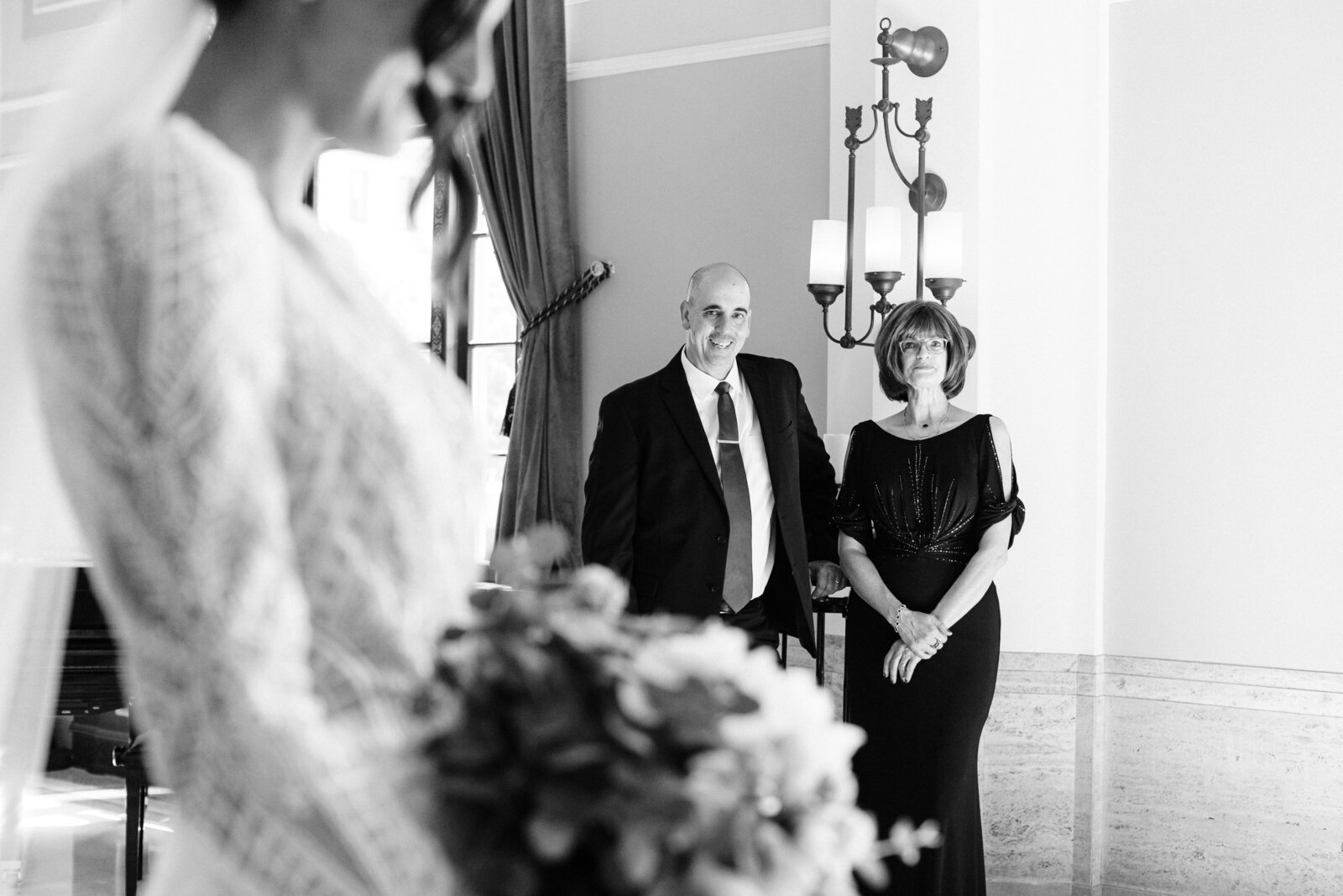 mom and dad admiring their daughter bride at the onesto