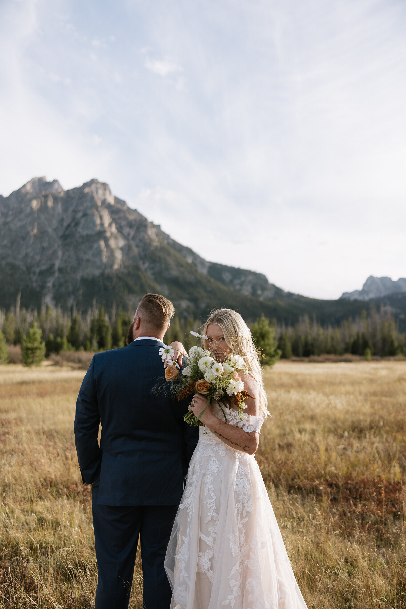Bride posing with bouquet during Idaho elopement at Stanley Lake