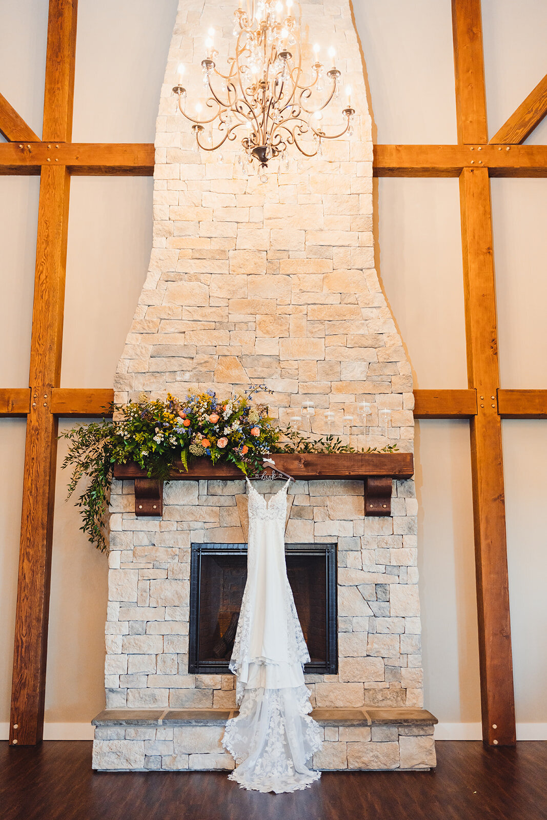 Luxury wedding fireplace floral with bridal gown