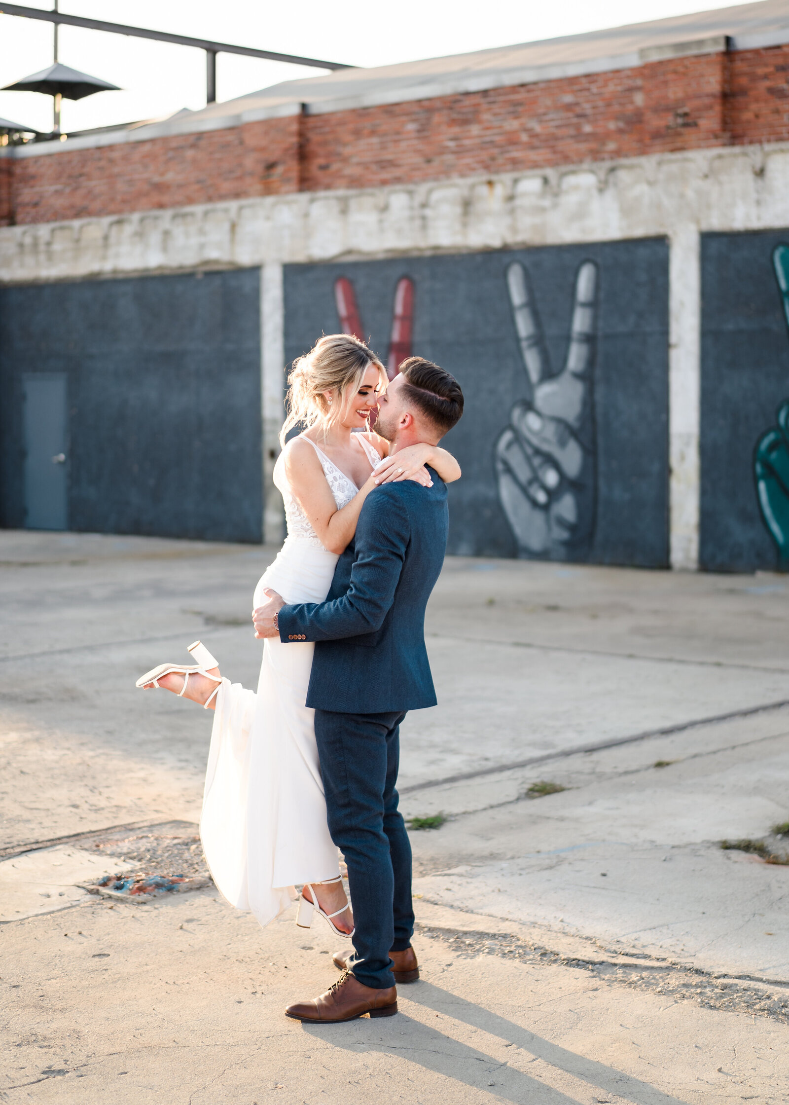 Groom lifts his bride outside Strongwater in Franklinton