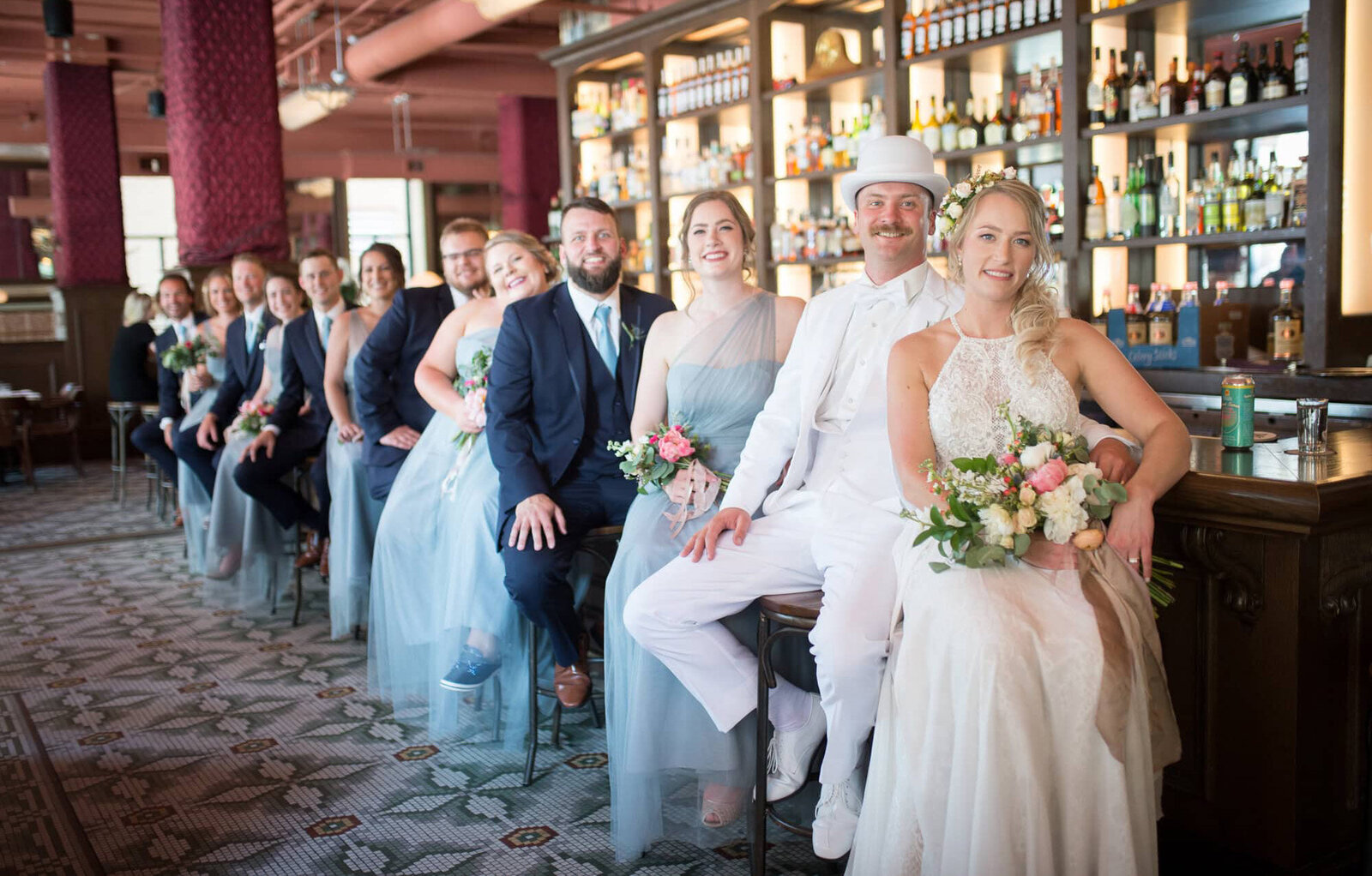 bridal party sit at bar together