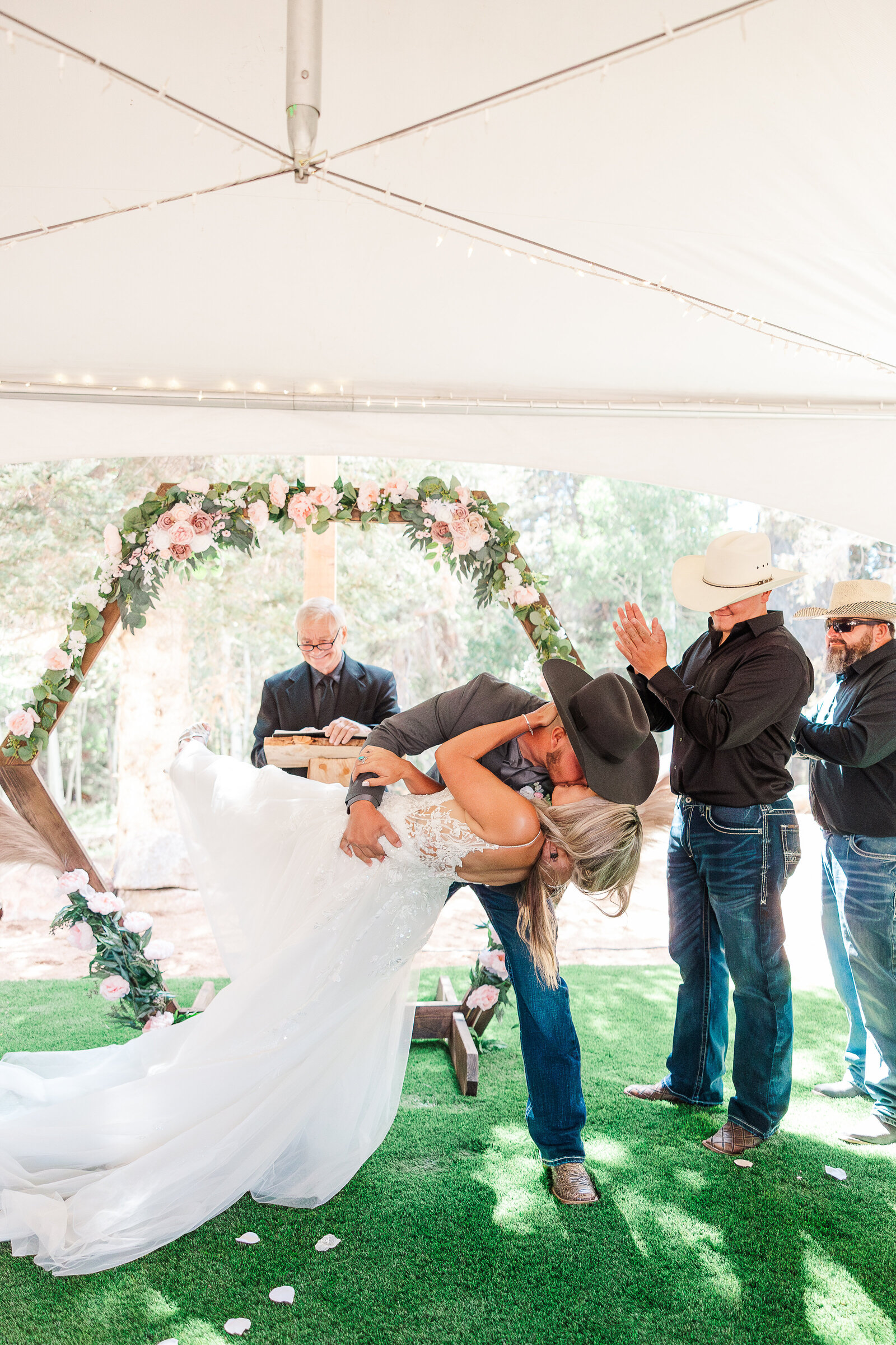 Beautiful moment captured as groom dips bride and kisses are as newlyweds