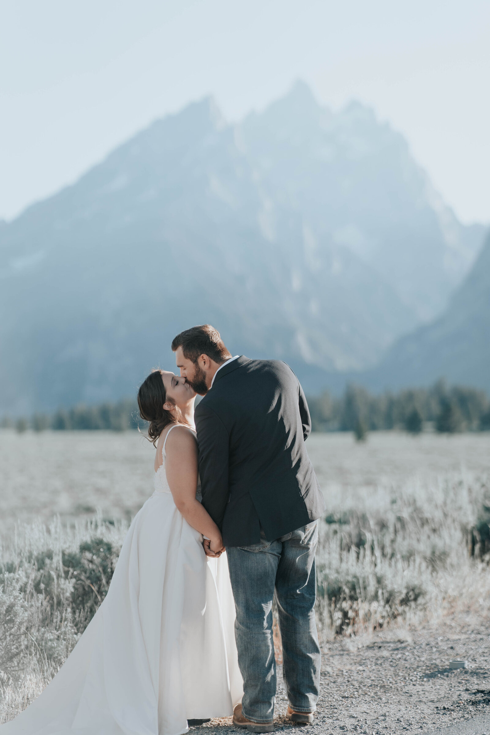 Bride and groom kiss in the sunset in the Grand Teton National Park captured by Idaho Falls wedding photographer