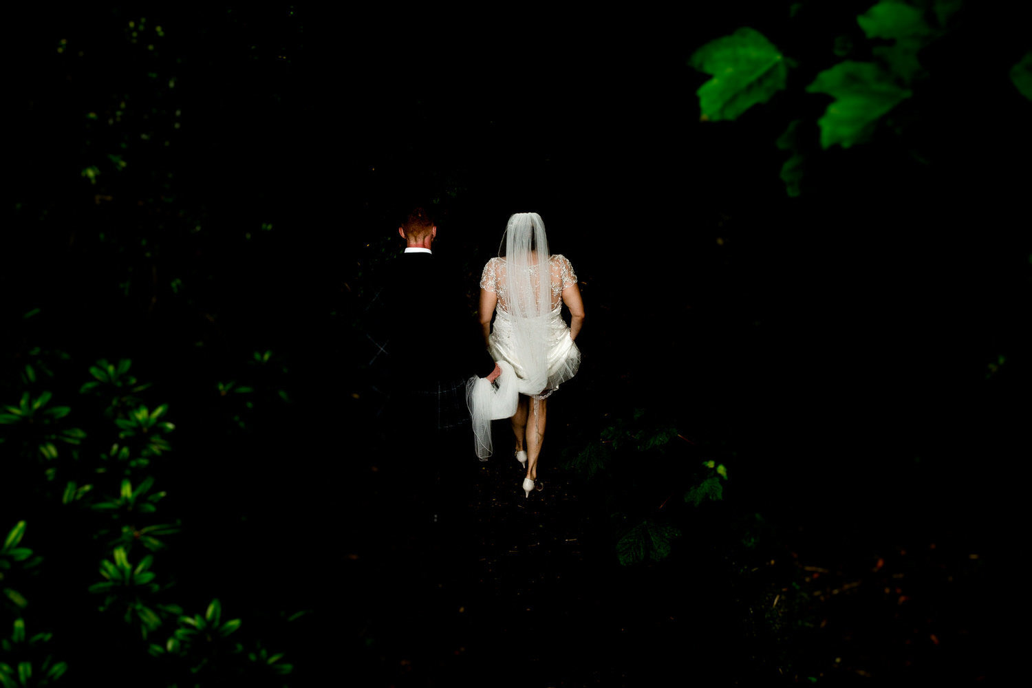 wedding couple go into the woods for a wedding portrait