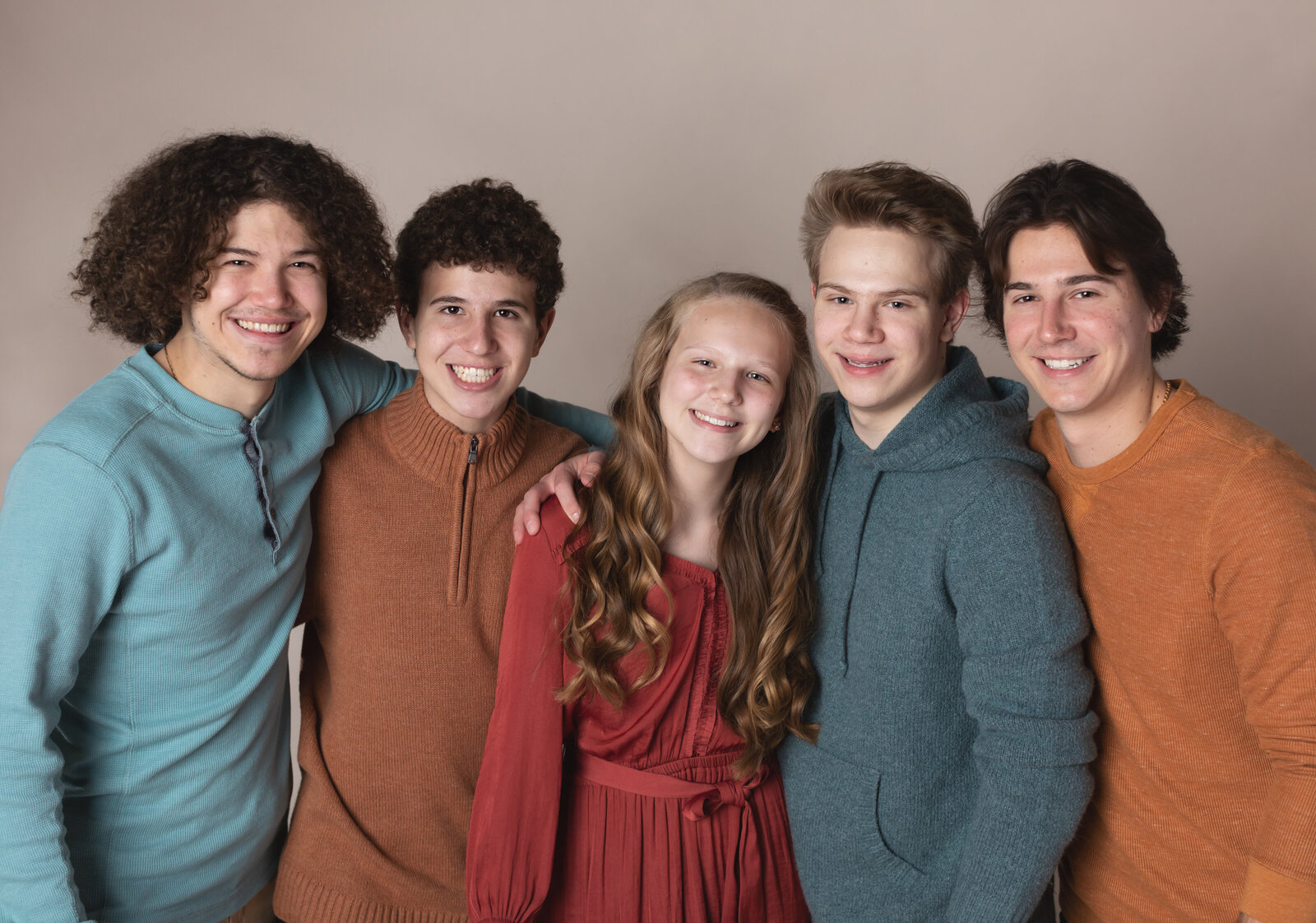 four brothers and sister posed for studio family portraits