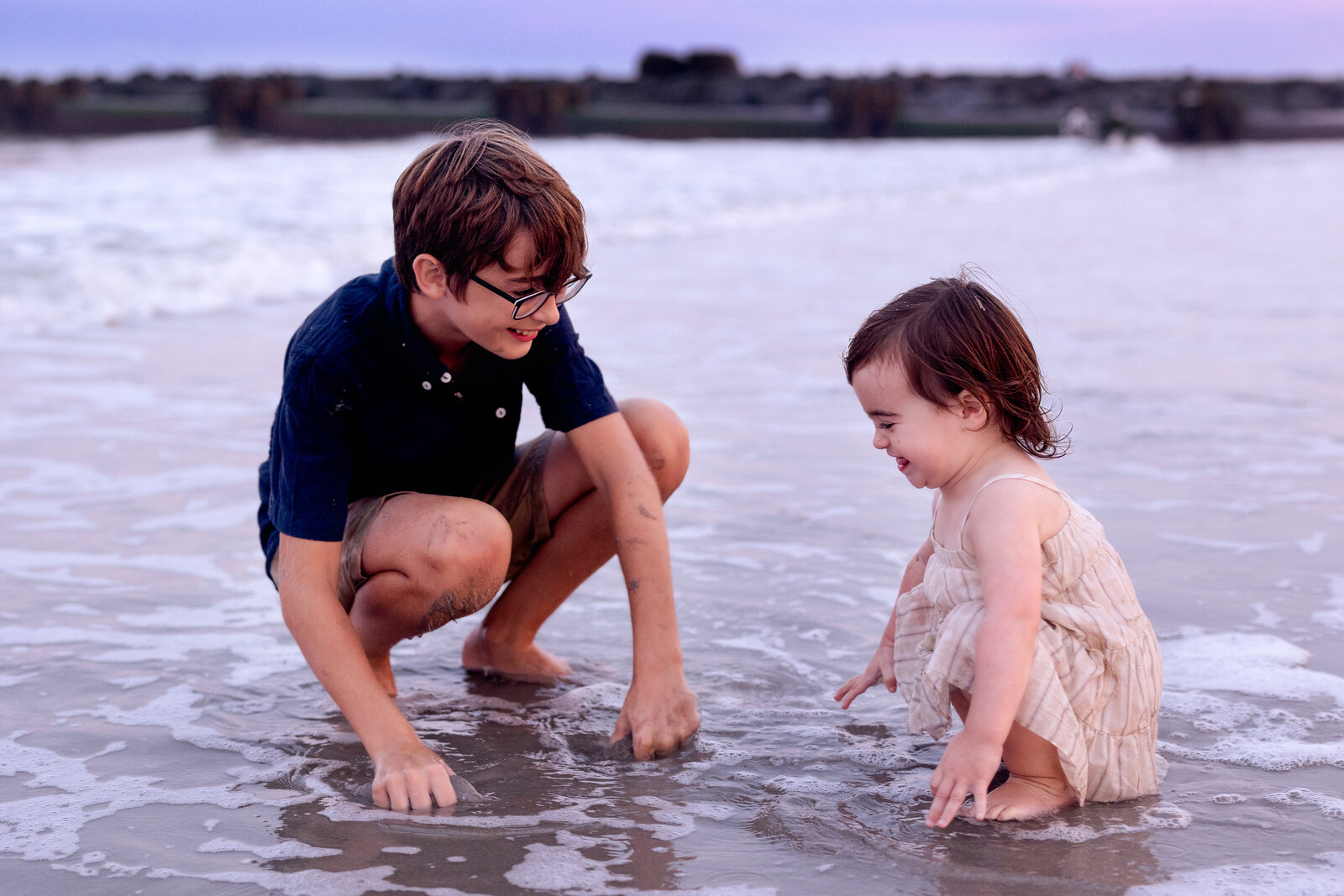 Young boy and toddler sister playing in the water on the beach in Ocean City, New Jersey
