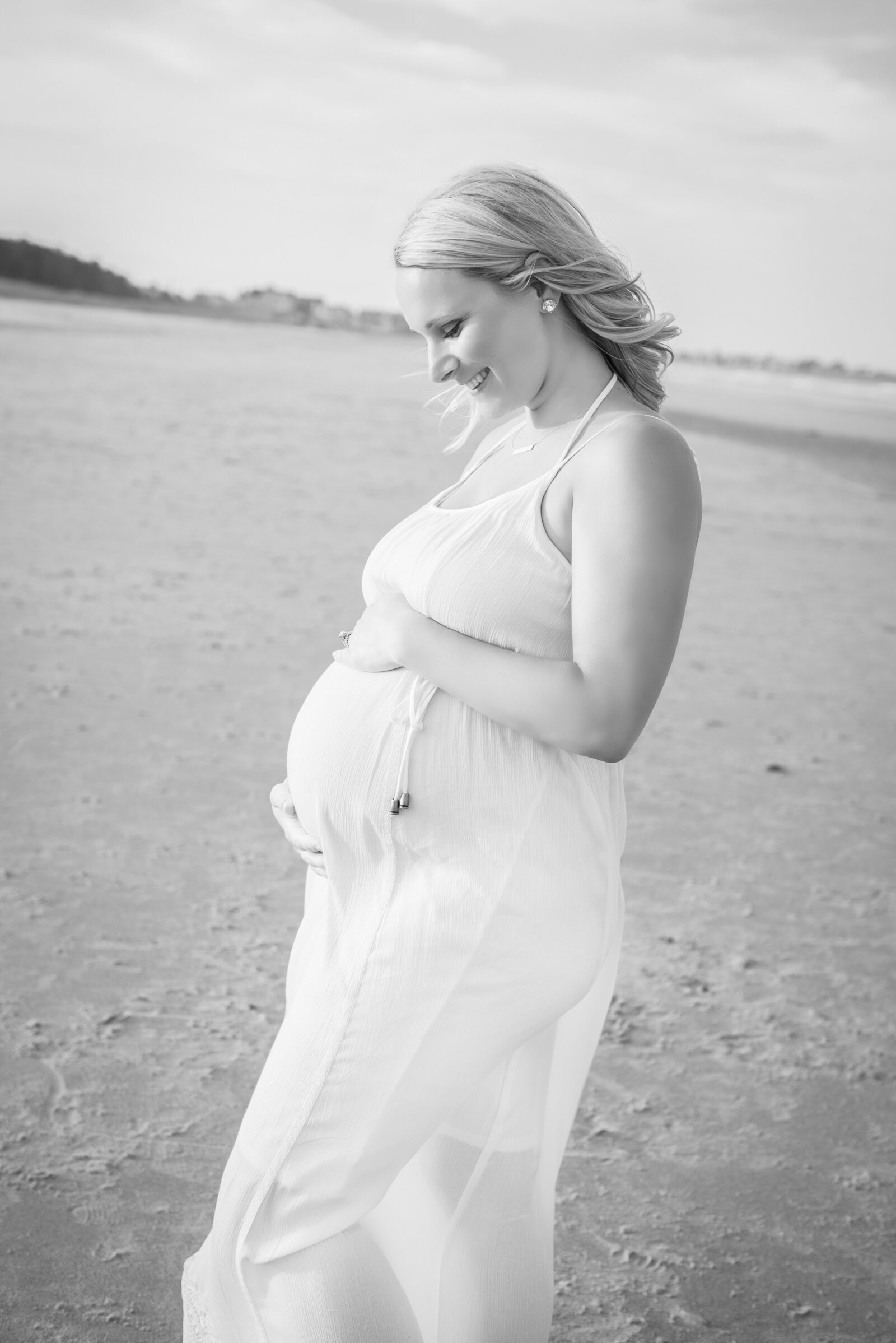Pregnant woman on beach in maternity photo in Wells Maine