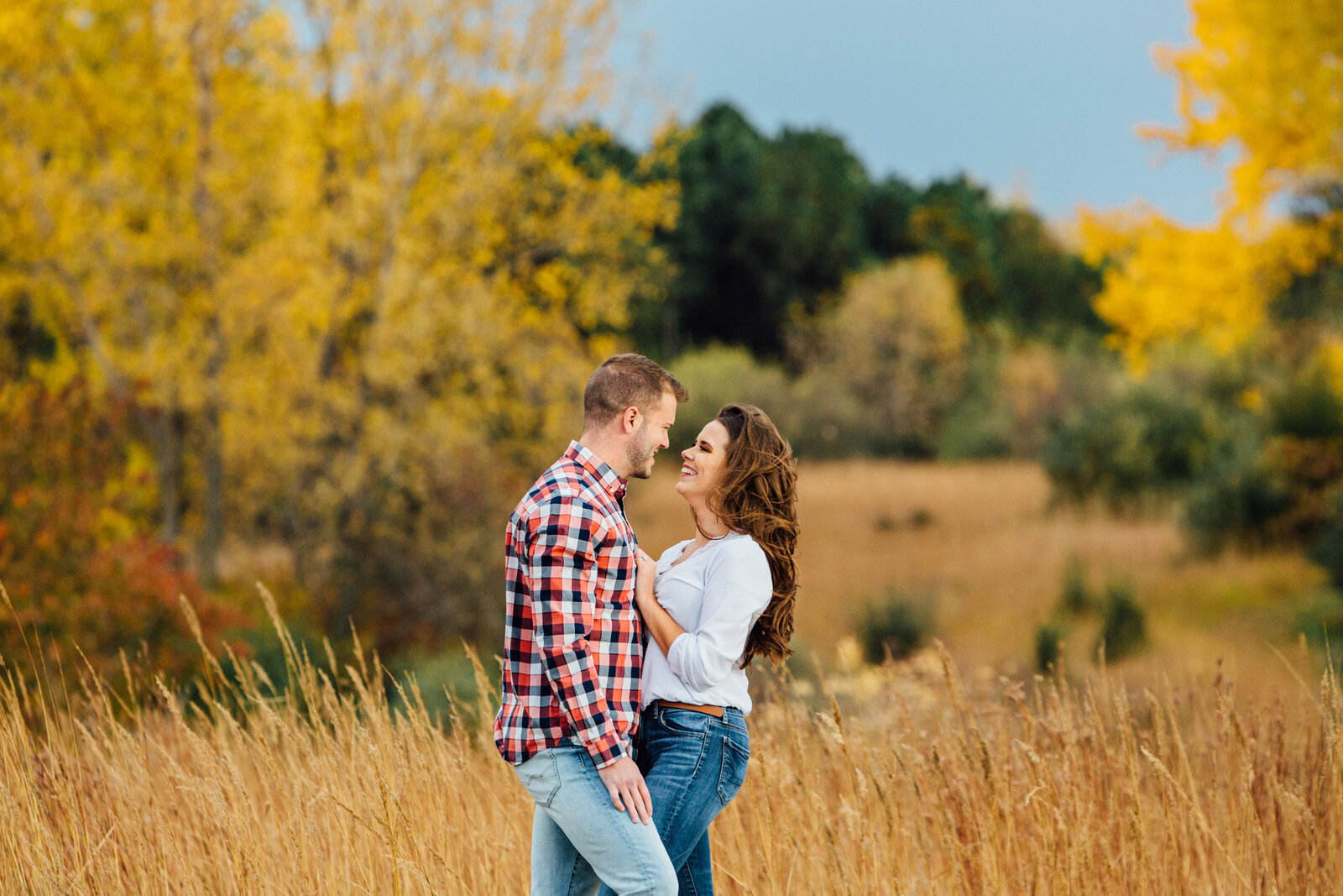 Engaged couple  looking at each other with fall colors