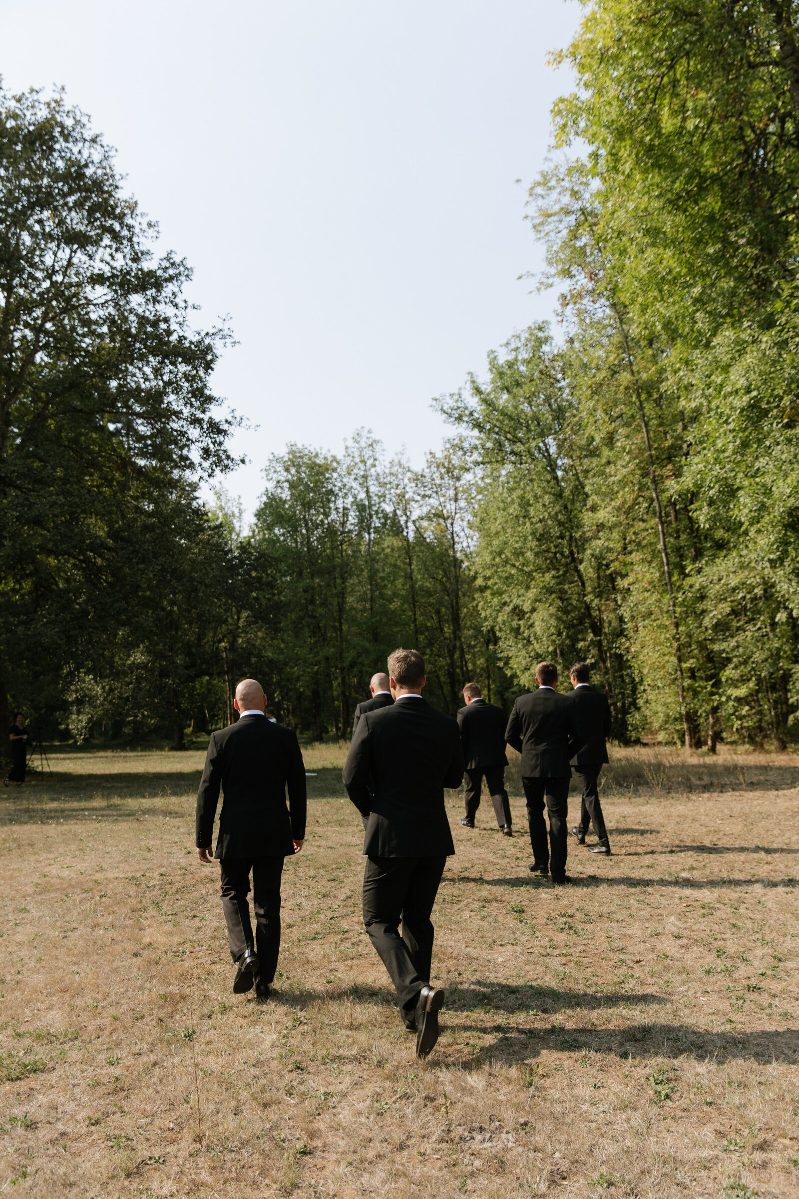 Groomsmen walking through mountain meadow by Washington wedding photographer