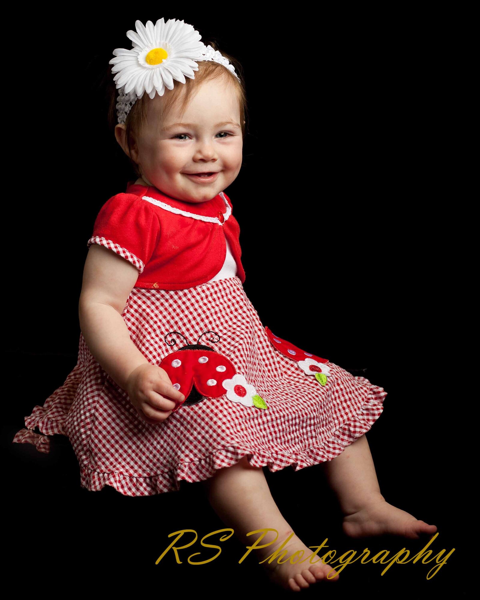 A little girl posing sitting  in studio shoot with Ron Schroll Photography in Asheville, NC