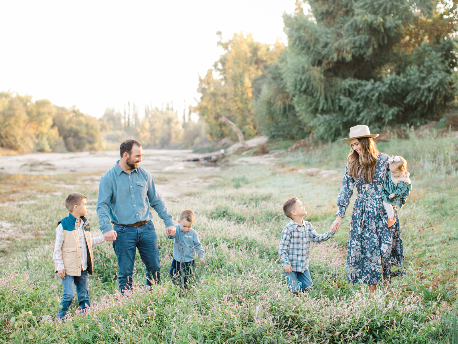 family of six walking by a stream