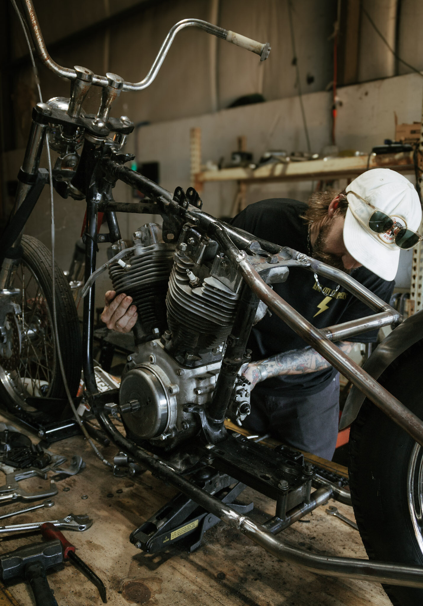 King City Choppers owner Drew pulling a Shovelhead engine out of a frame