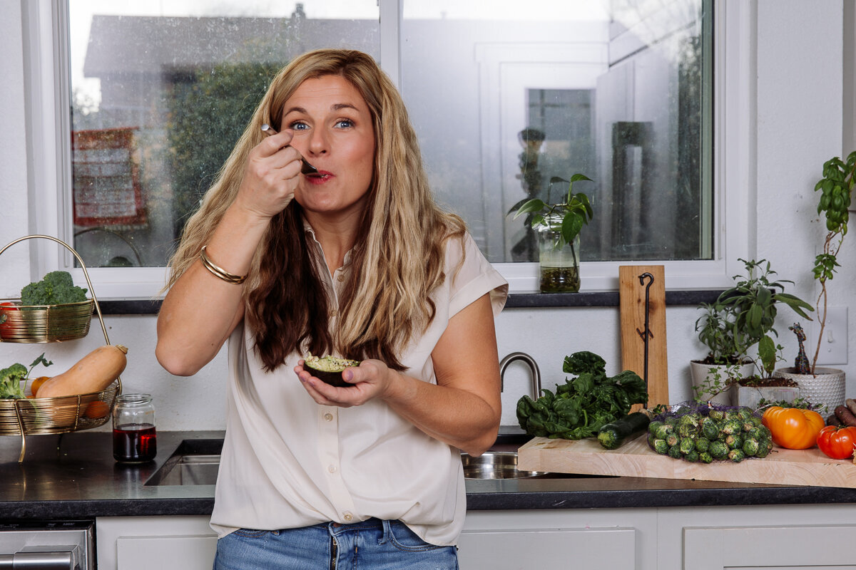 amy eating a nutritional snack in her kitchen